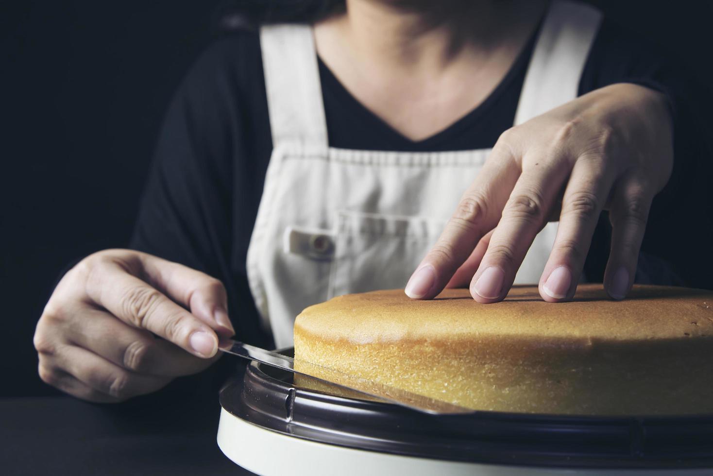 Lady making cake putting cream using spatula - homemade bakery cooking concept photo