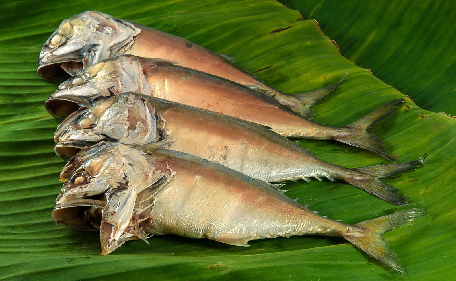 Steamed mackerel on banana leaves ready to be cooked photo