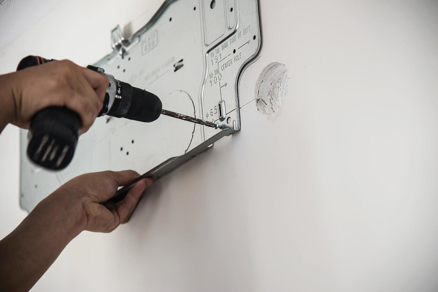 Technician is installing house air conditioner during hot season photo