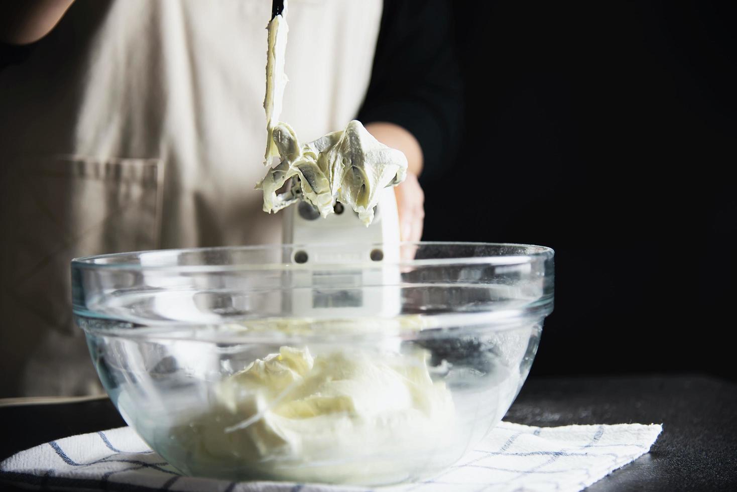 Lady making cake putting cream using spatula - homemade bakery cooking concept photo