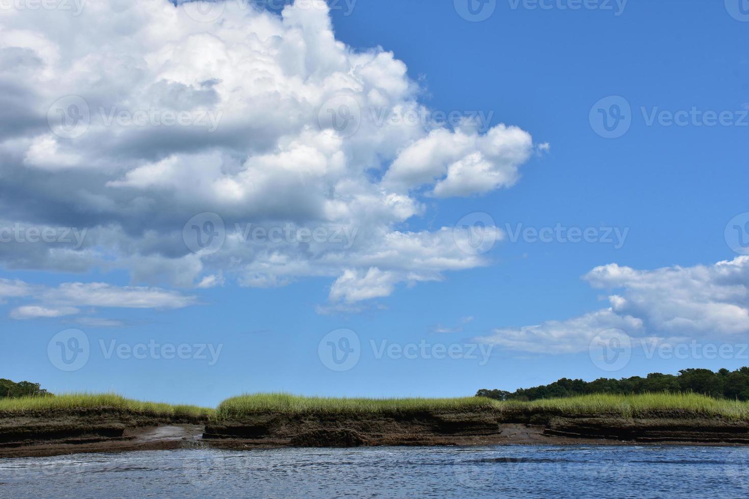 Fluffy White Clouds Over Marsh and Tidal River photo