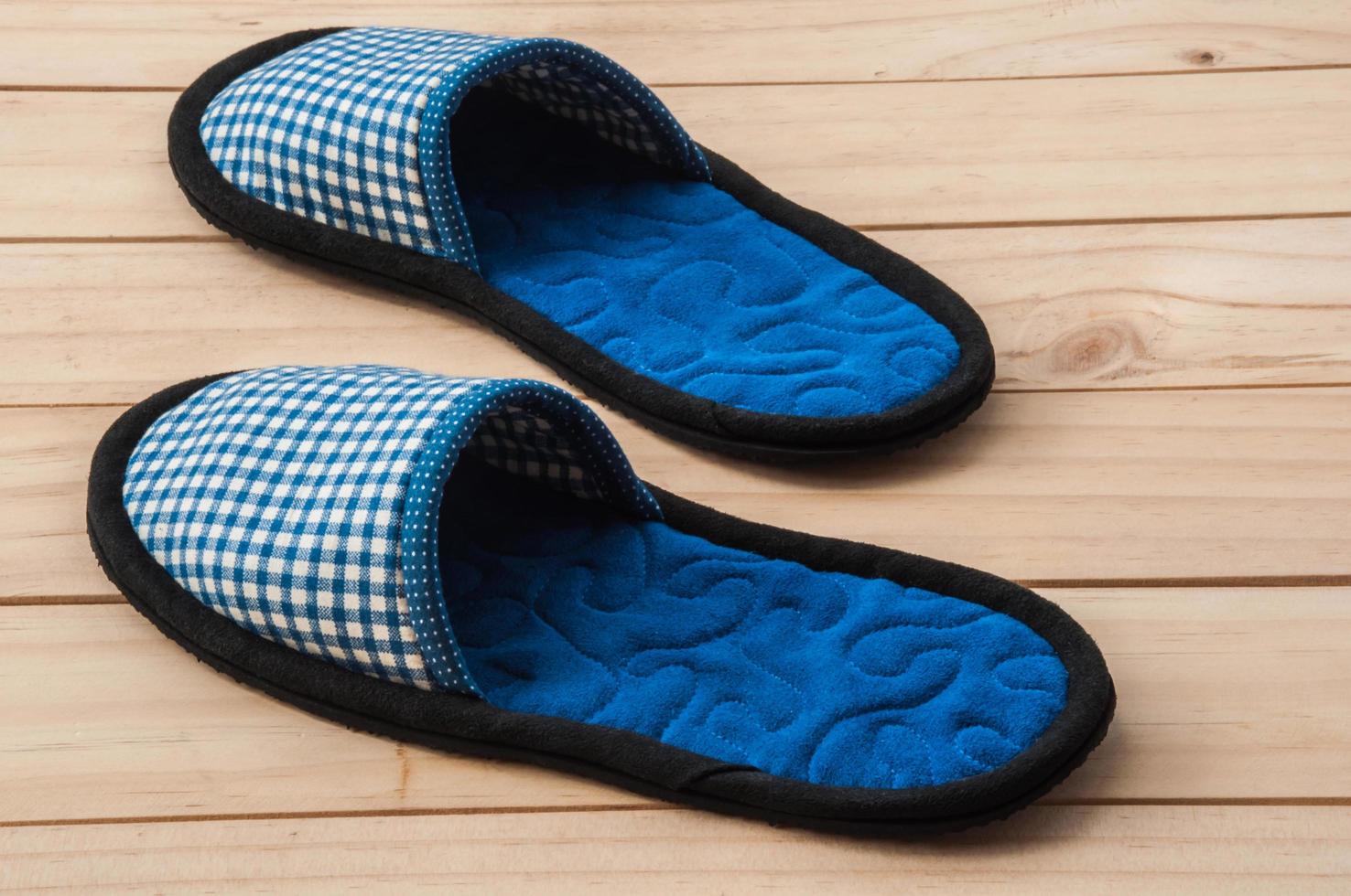 Indoor handmade soft shoes on wooden floor photo