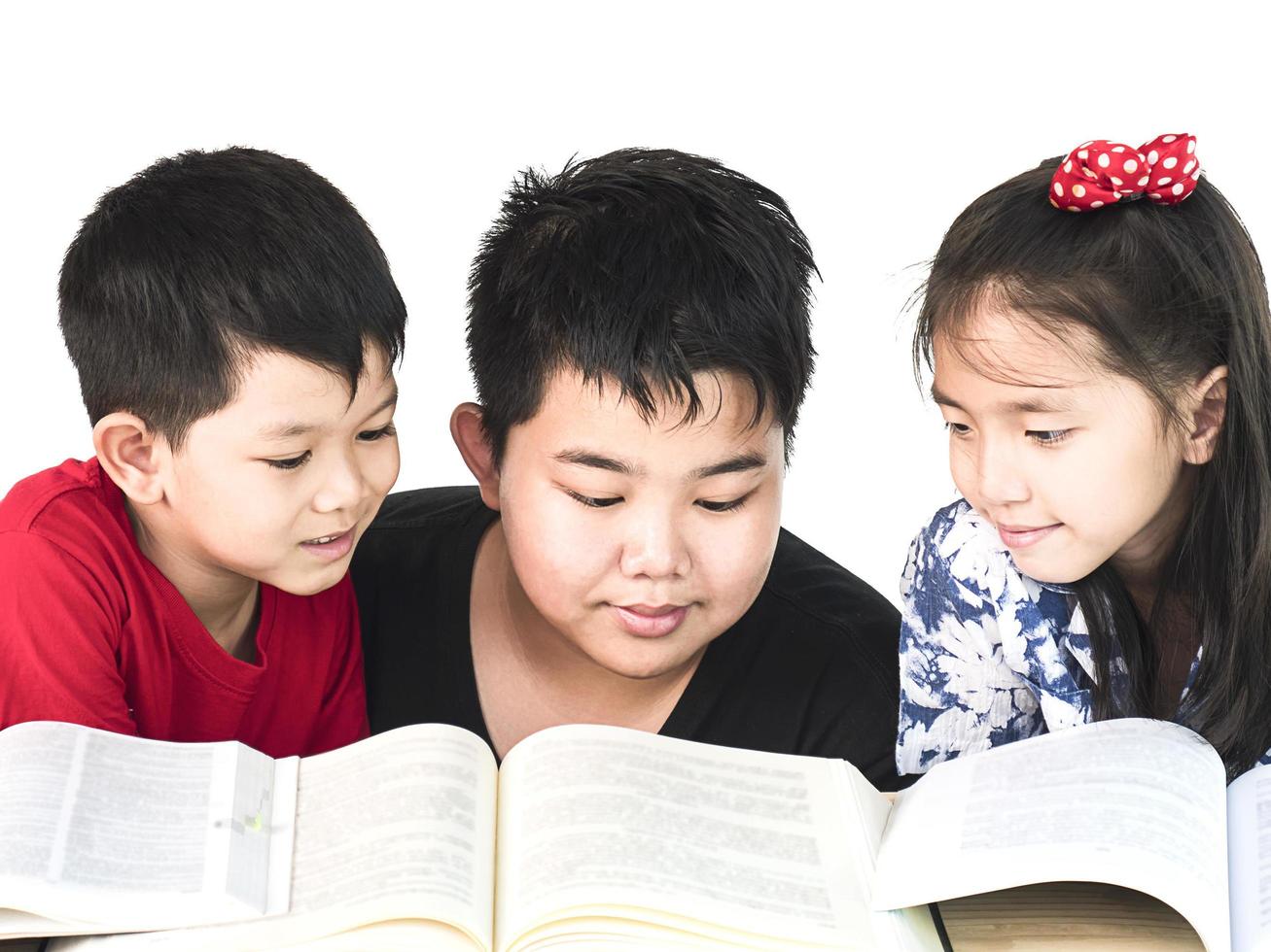 Curious children reading book together photo