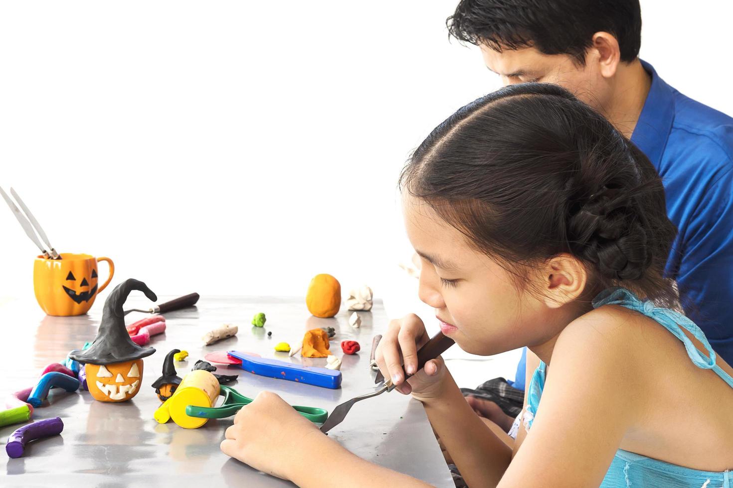 Father is playing clay toy with kid photo