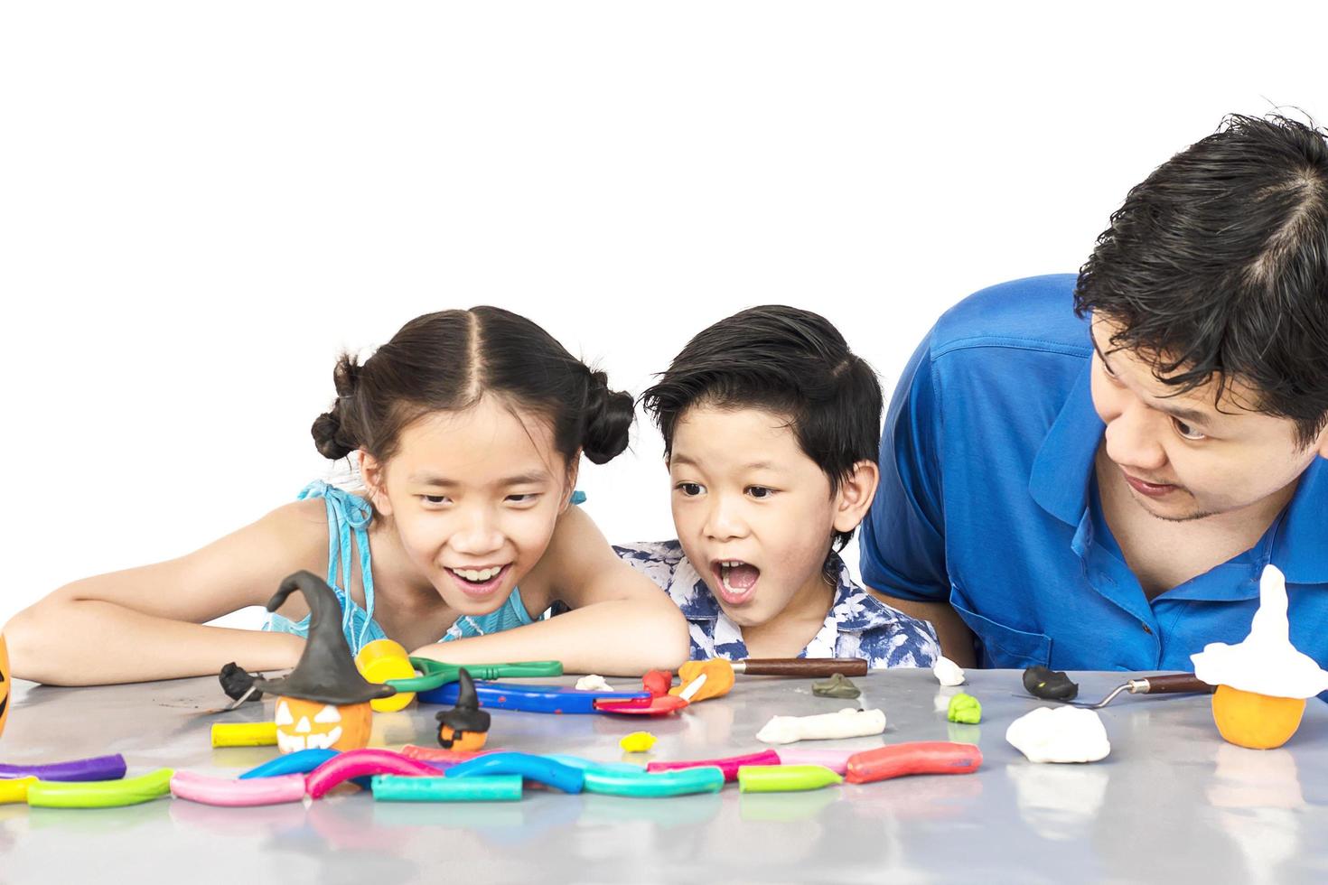 Father is playing clay toy with kid photo