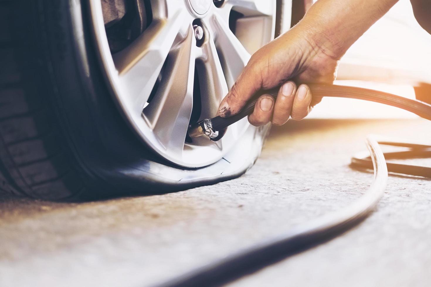 Technician is repairing car flat tire photo