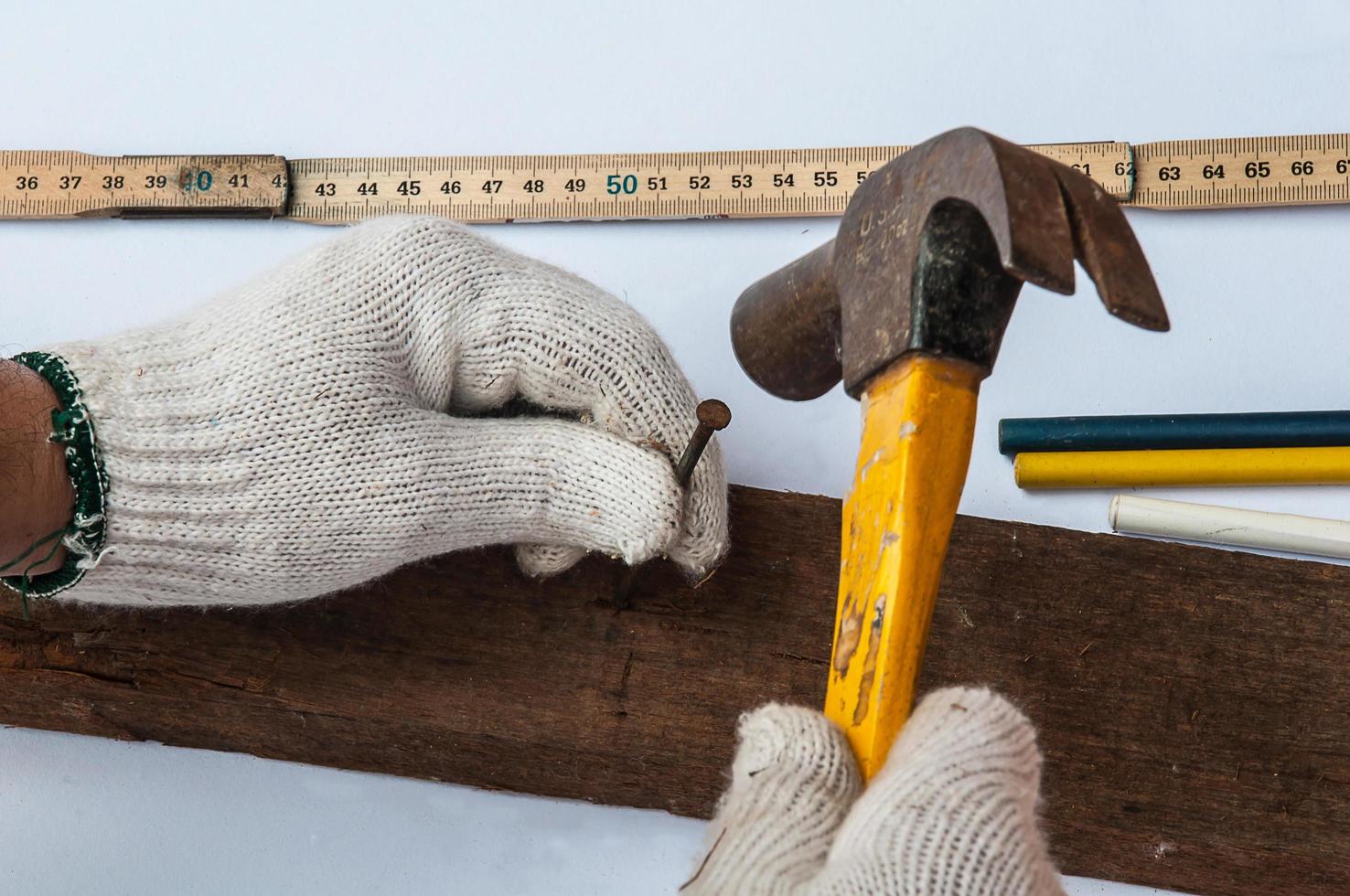 Using hammer and nail on wood photo