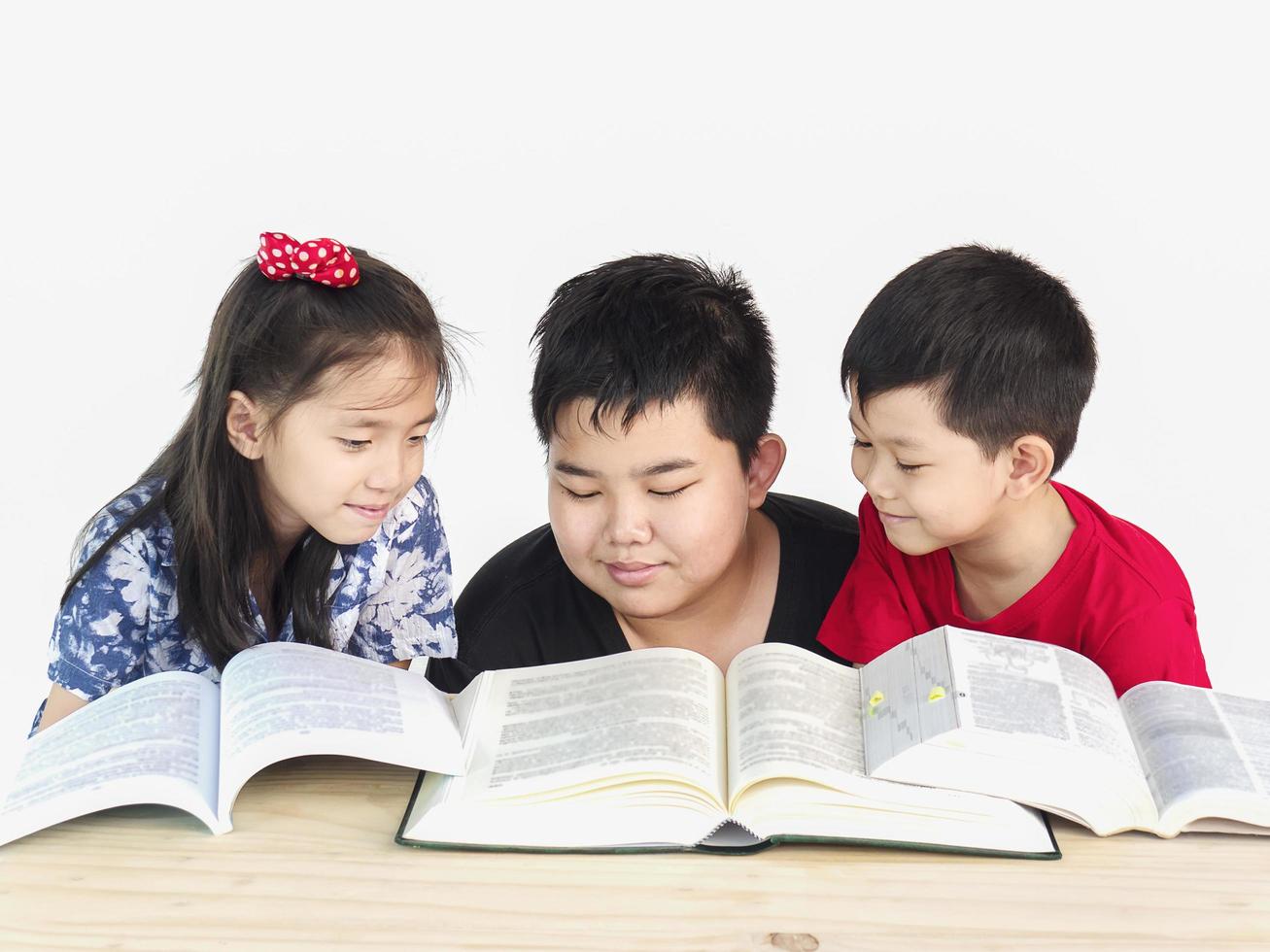 Curious children reading book together photo