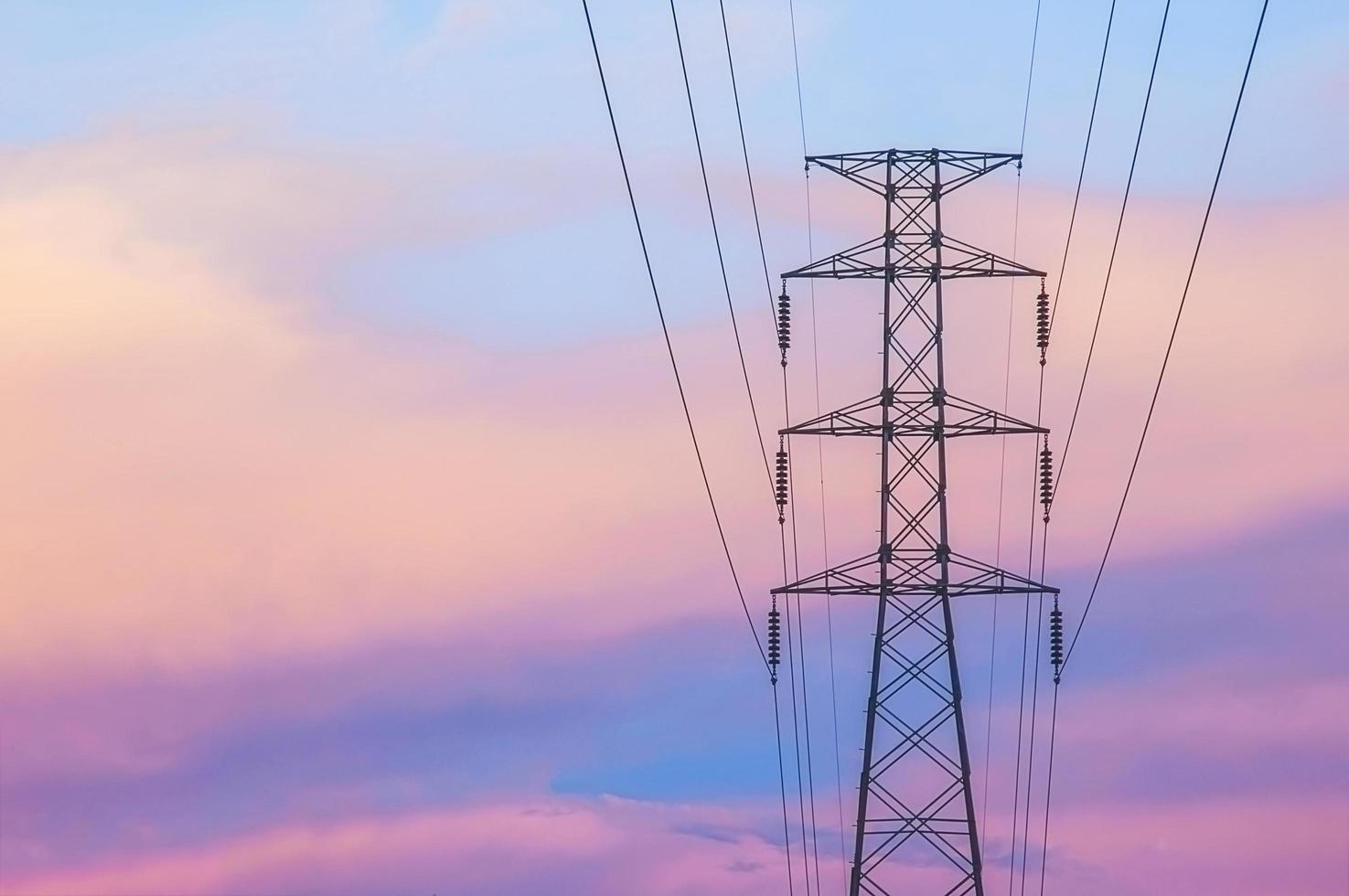 High voltage power transmission tower in twilight photo