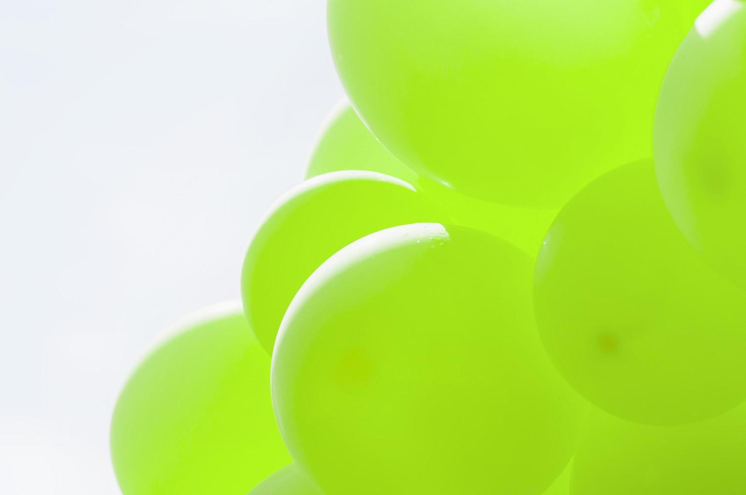 Green balloon with blue bright sky background photo