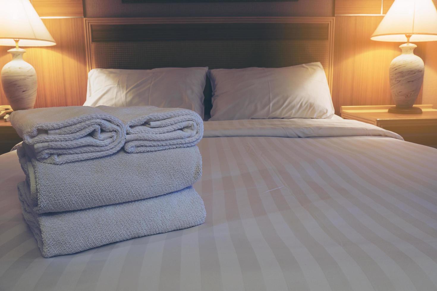 White bedding and towel set in modern hotel photo