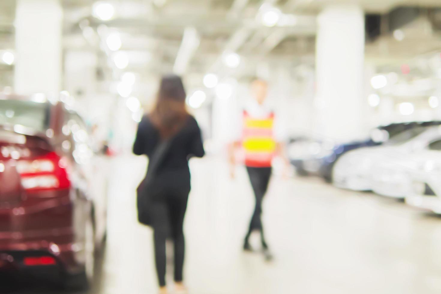 Blurred photo of a woman is walking dangerously in a car parking area