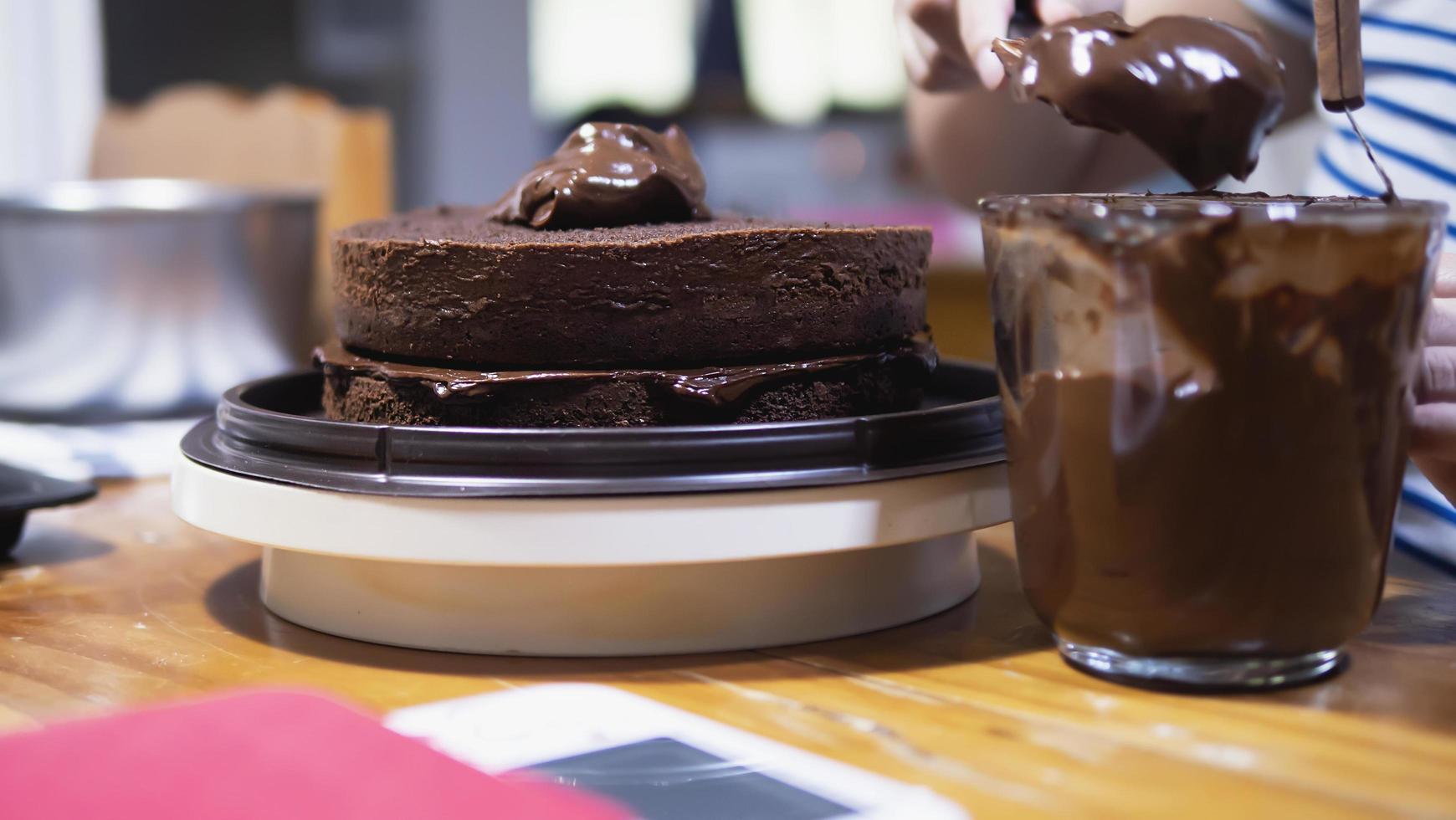 Lady making chocolate cake - people with home made bakery concept photo