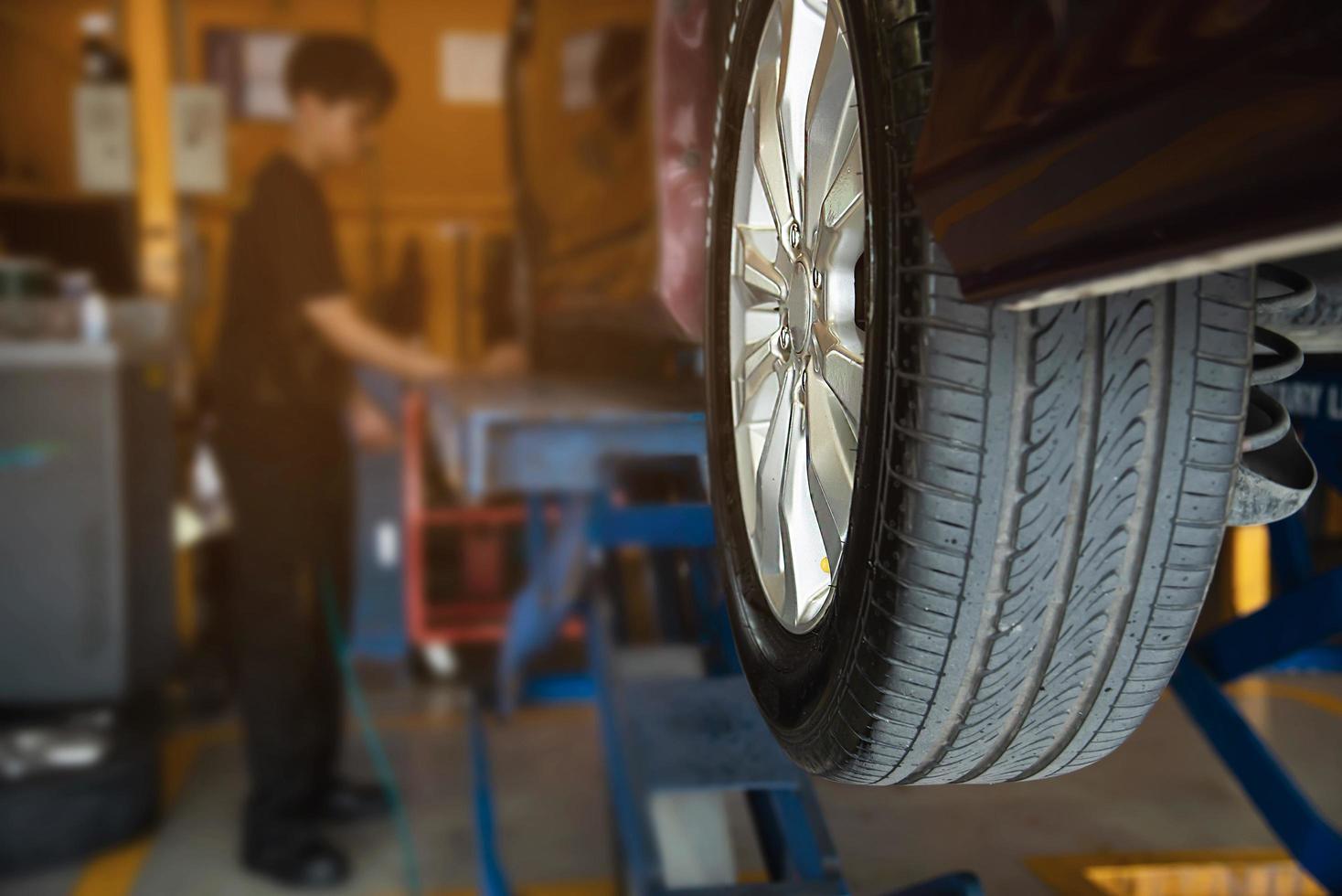 Technician is inflate car tire - car maintenance service transportation safety concept photo