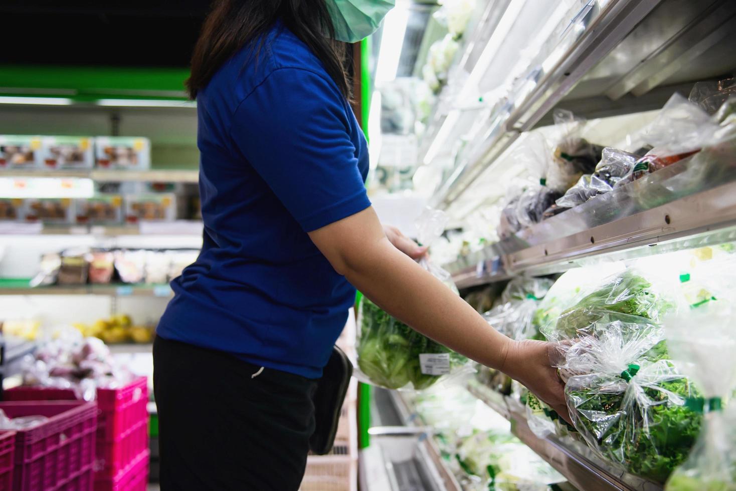 Woman shopping fresh fruit during COVID-19 spreading in Thailand local fresh market photo