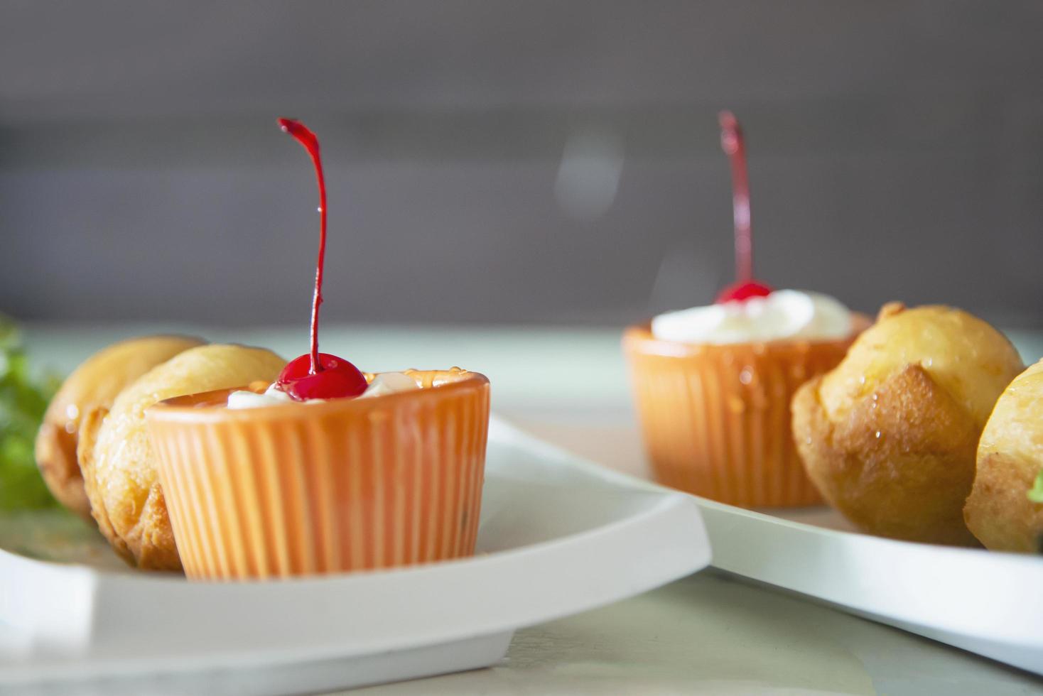 Close-up fried bakery dish with red cherry photo