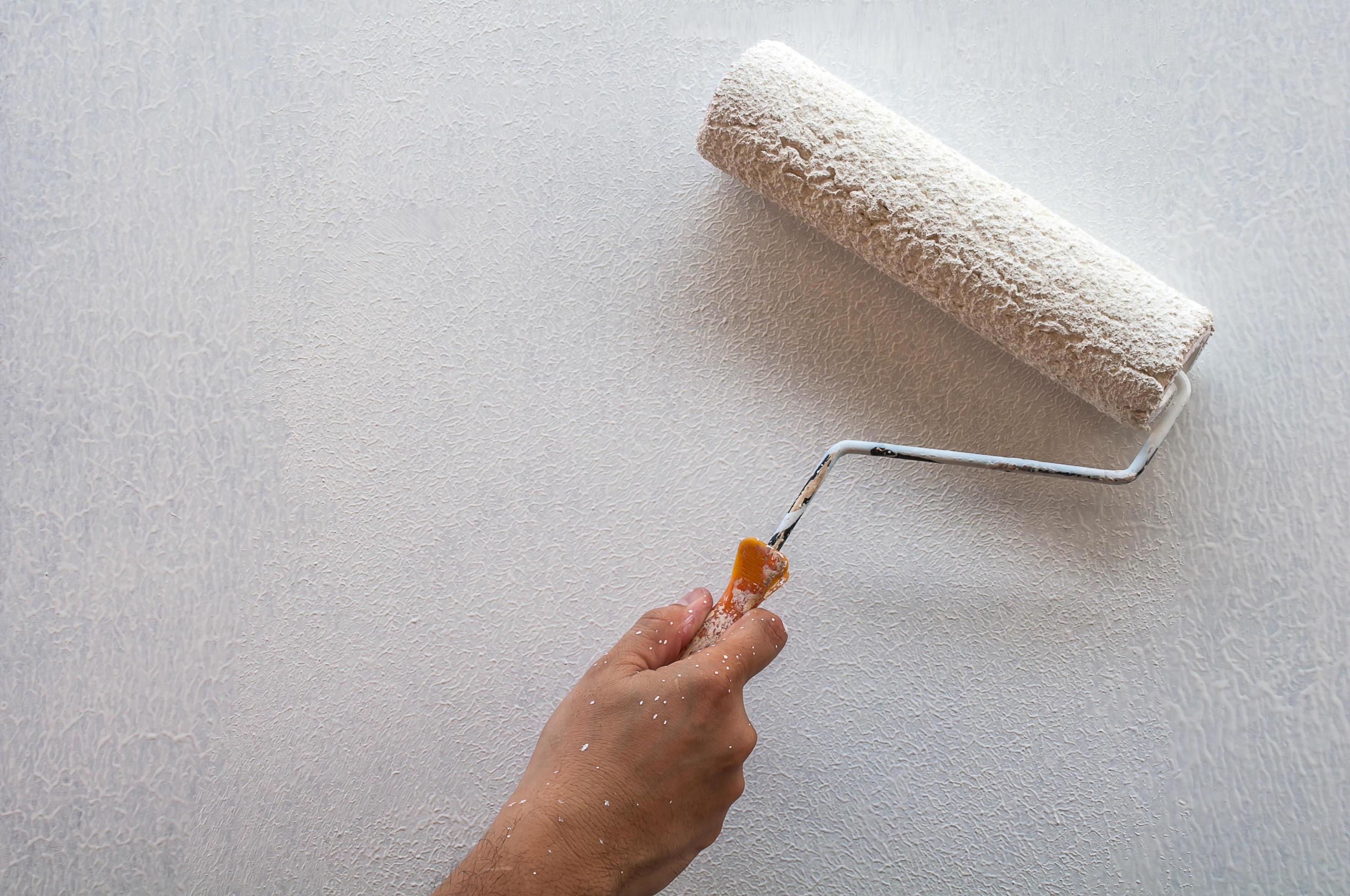 Hand holding rolling paint brush, wall painting 9303404 Stock Photo at