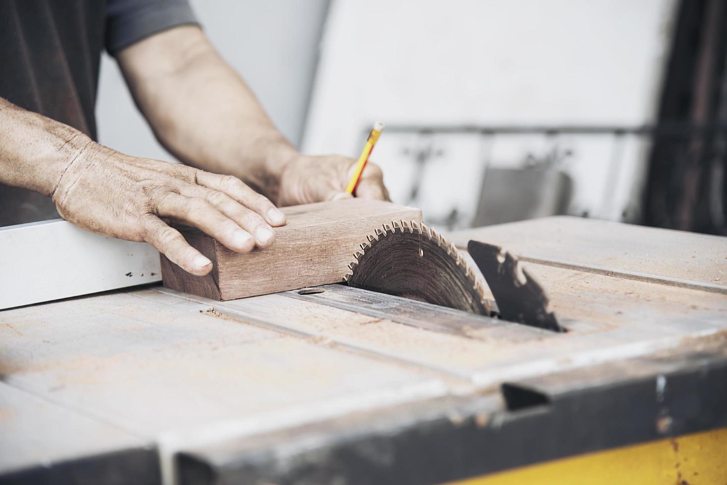 Man preparing electric router laminate trimmer machine tool - carpenter workshop concept photo