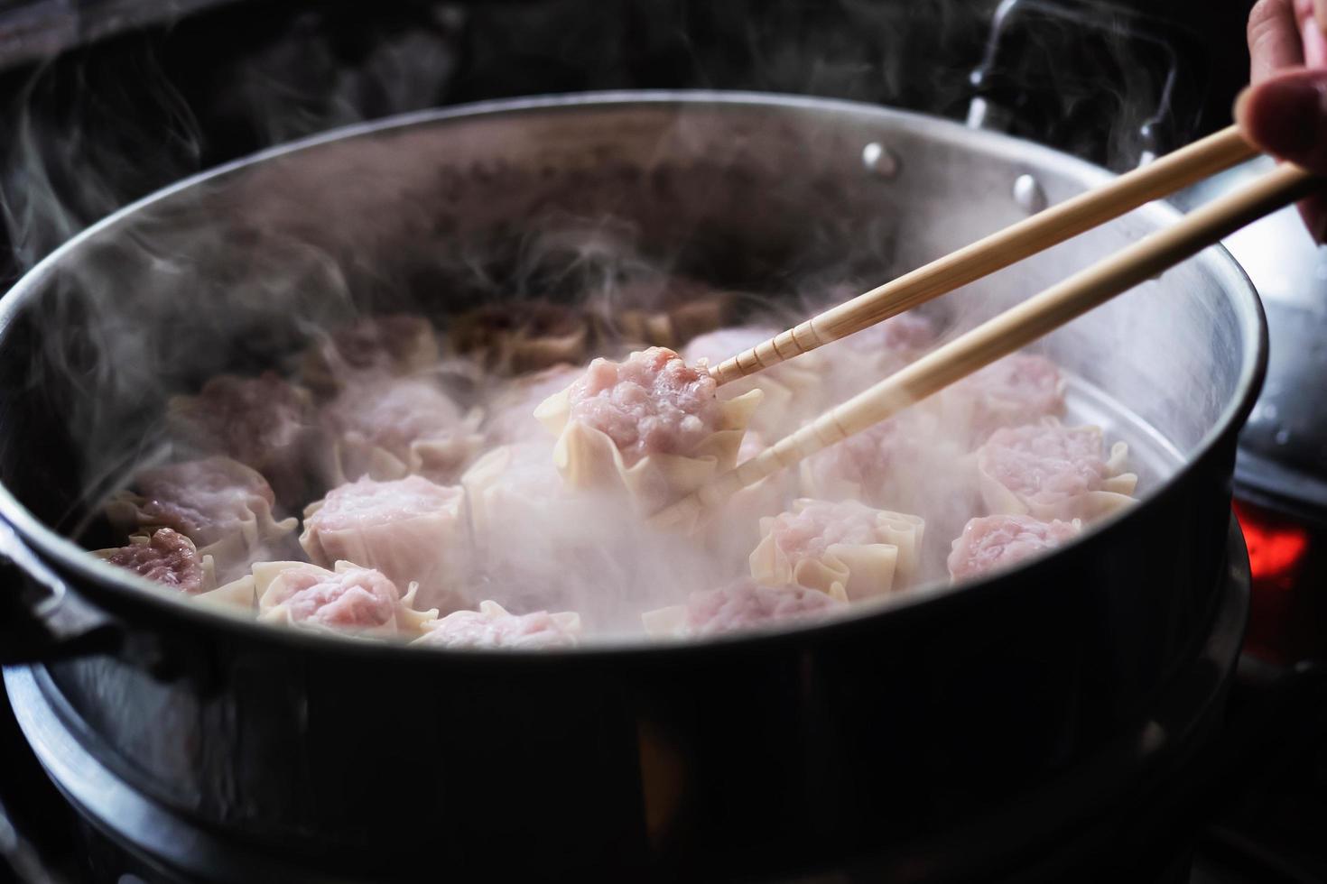 Chef is making traditional homemade Chinese pork dumplings recipe photo