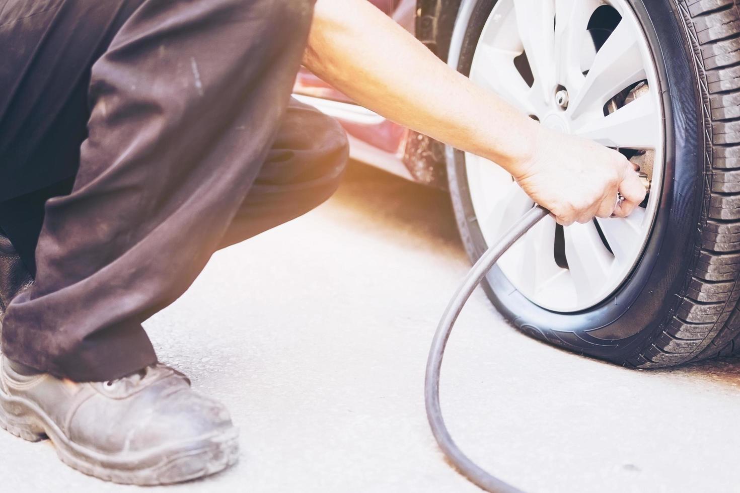 Technician is repairing car flat tire photo