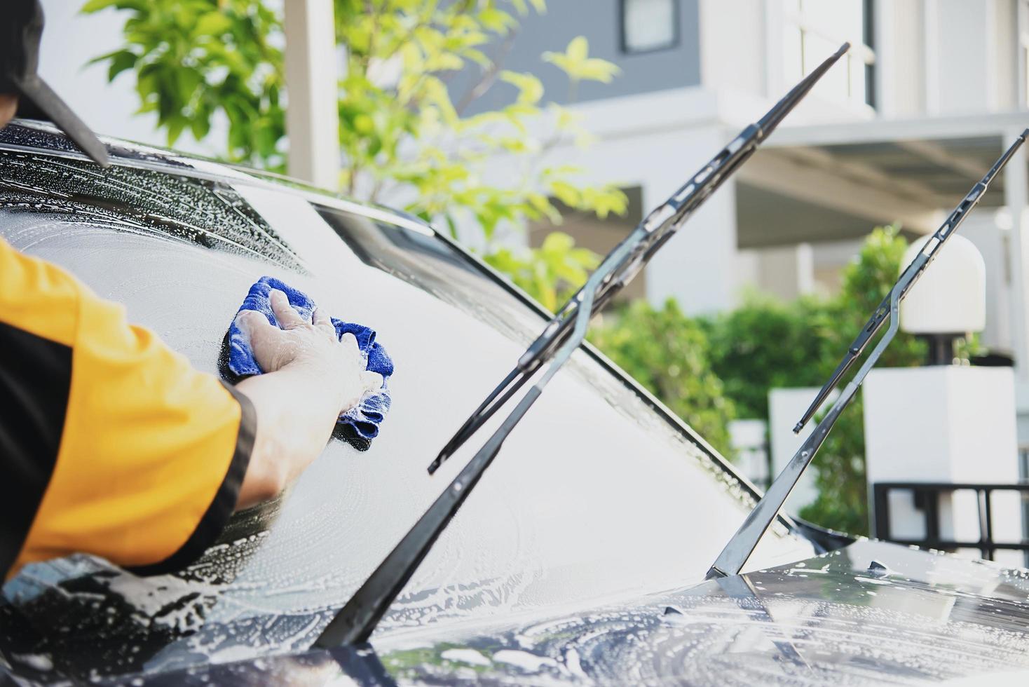 Man wash car using shampoo - every day life car care concept photo