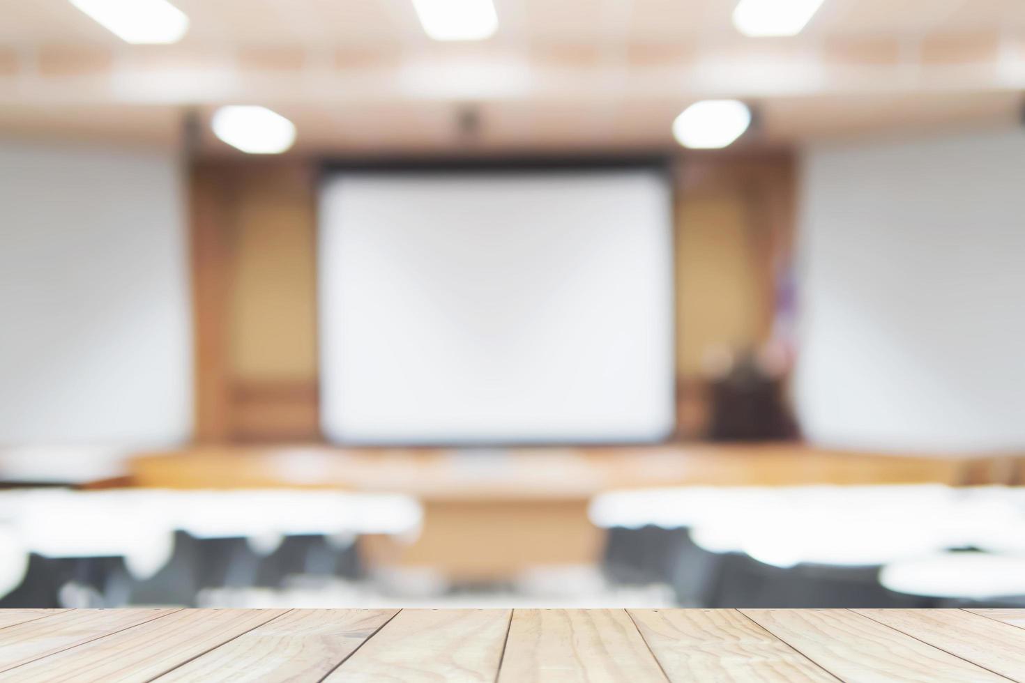 Wooden plank floor over blurred of empty lecture room photo