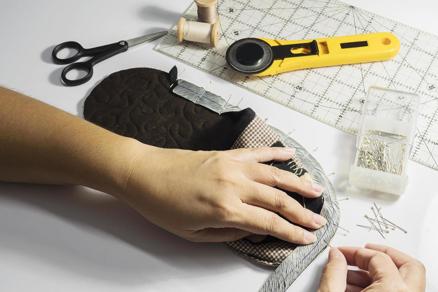 Lady is making handmade cloth soft shoe photo