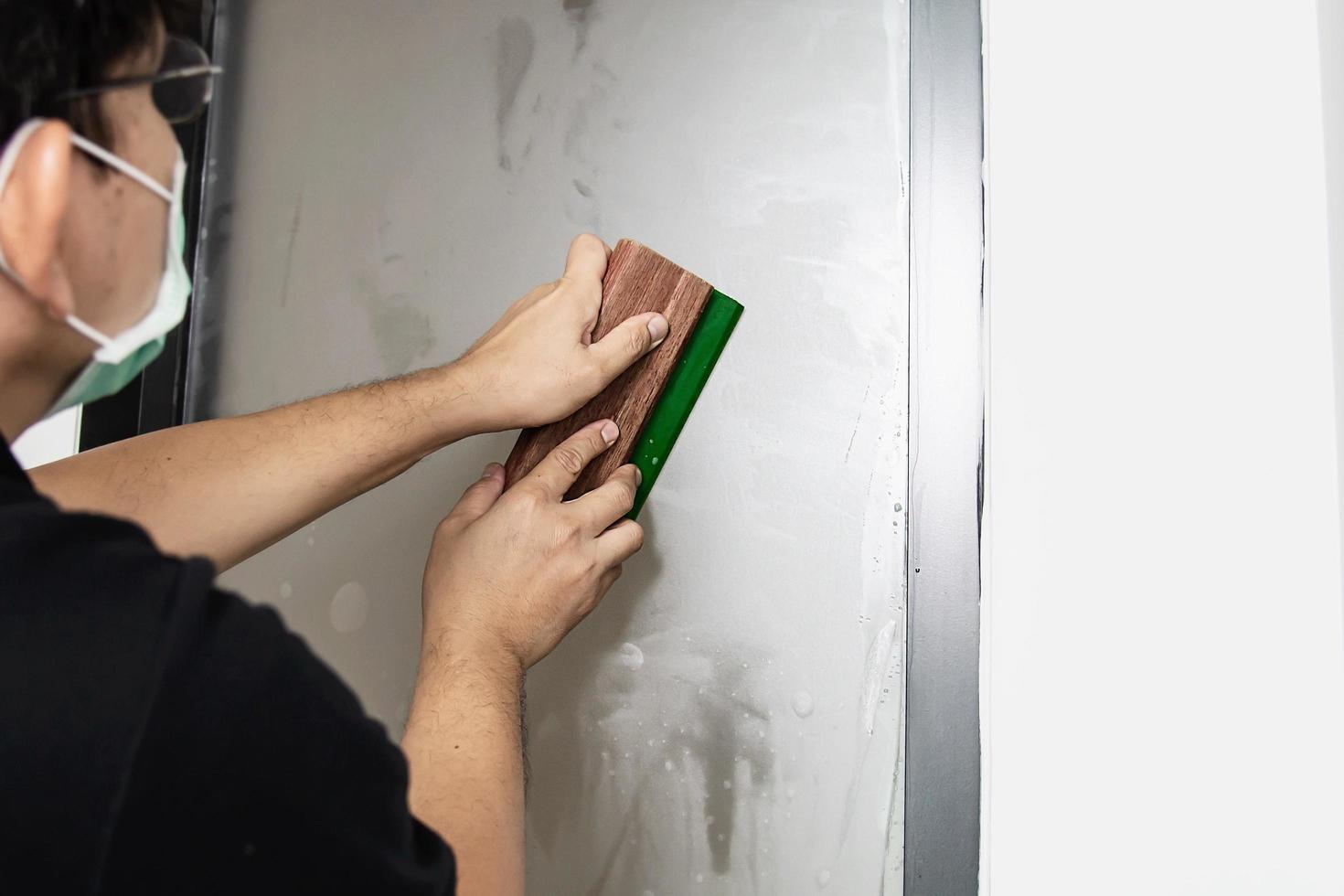 People installing sticker film to mirror window house interior decoration photo