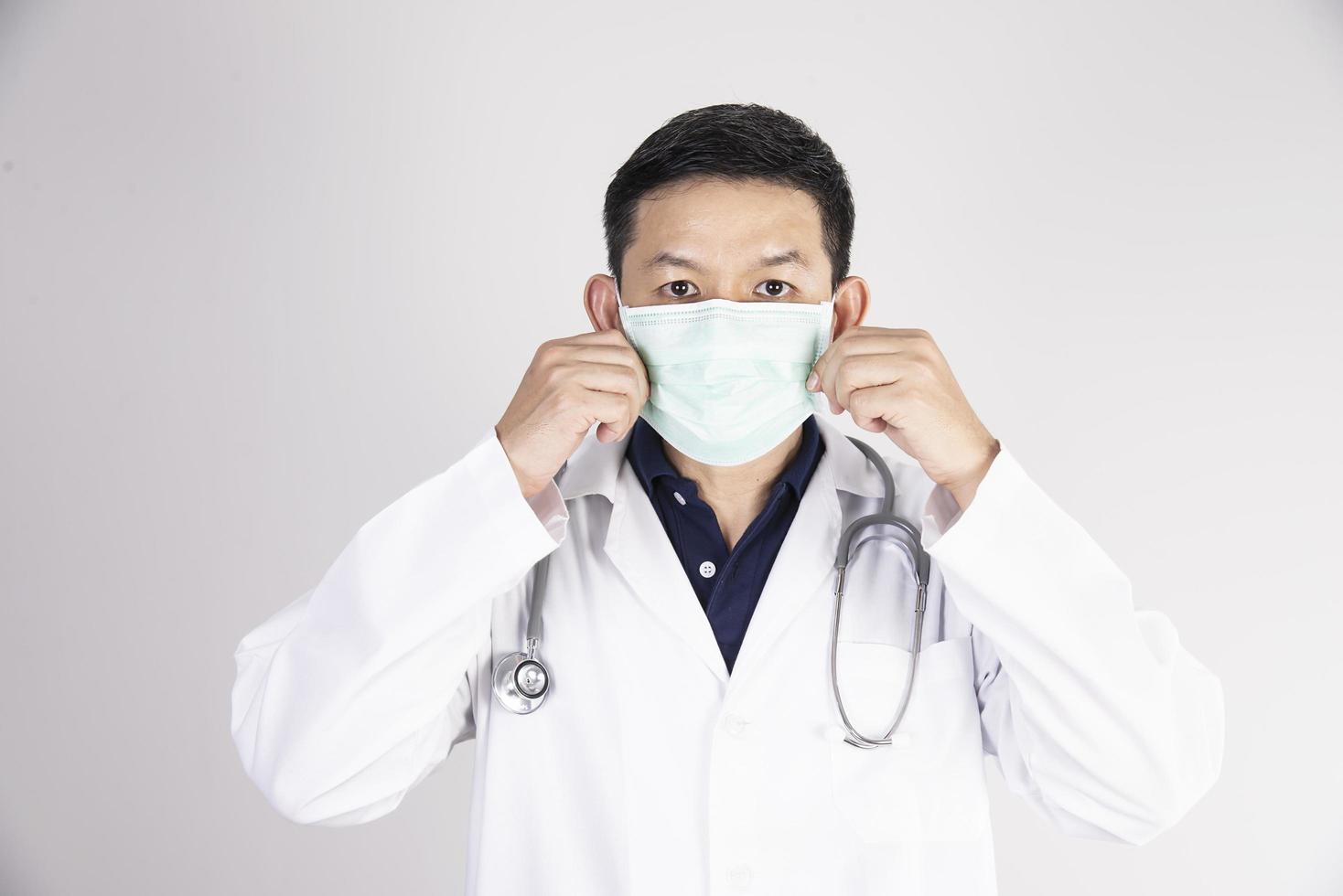 Asian doctor is wearing double layer masks for protecting Covid-19 virus - medical people working concept photo