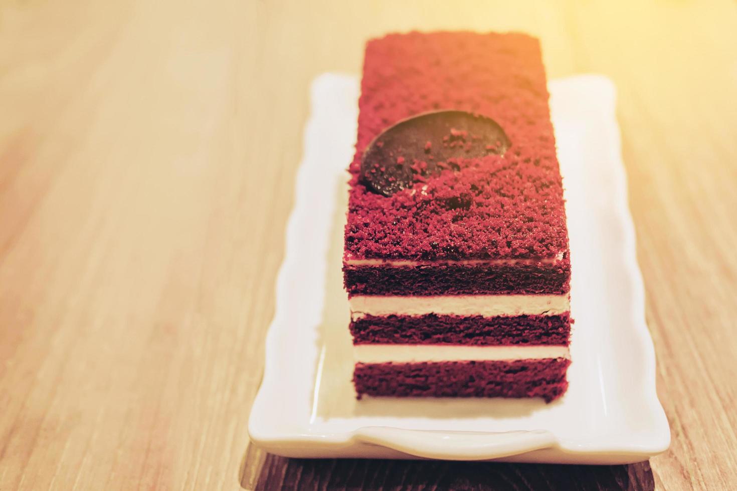 Red velvet cake on wooden table photo