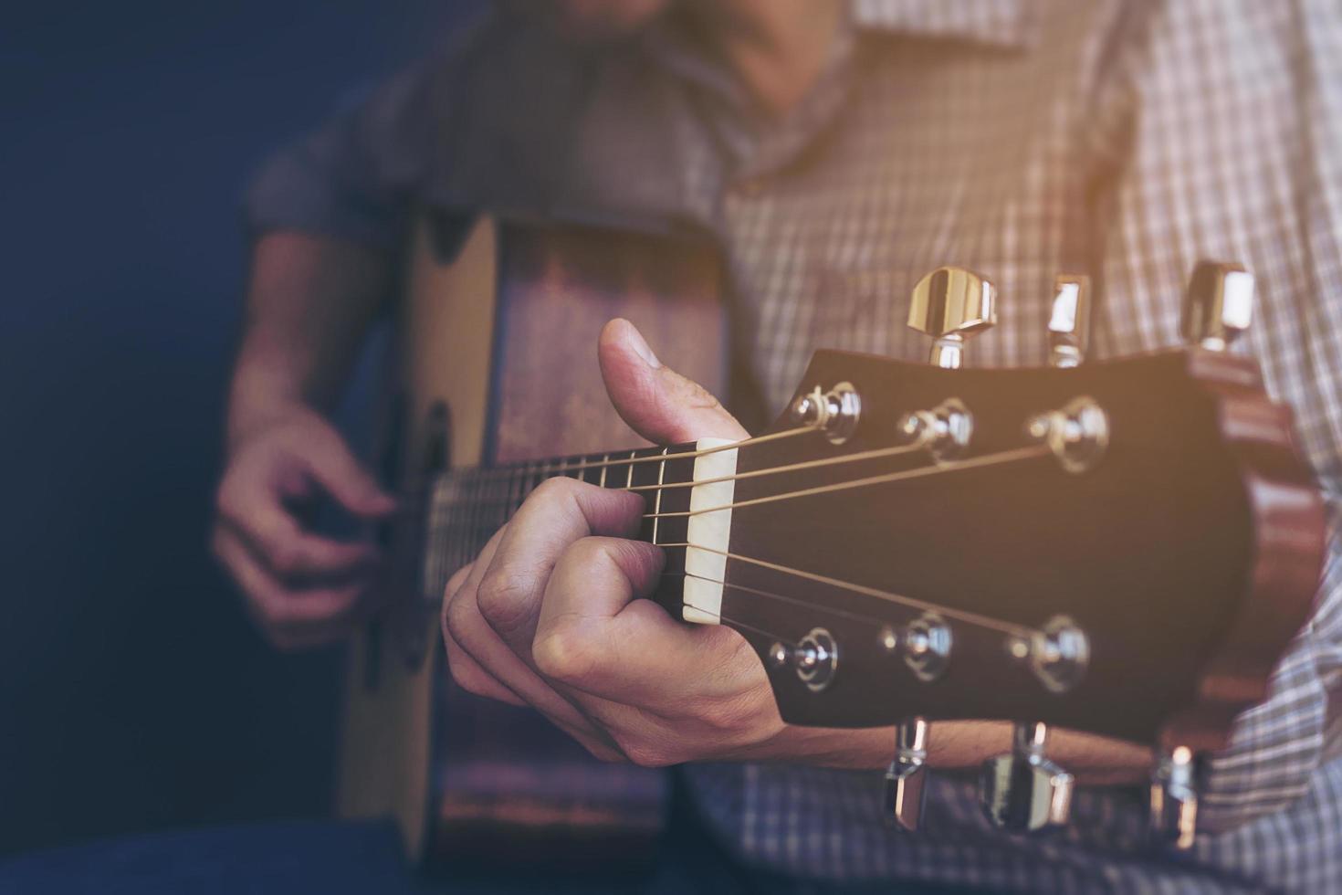 Closeup of man playing guitar photo