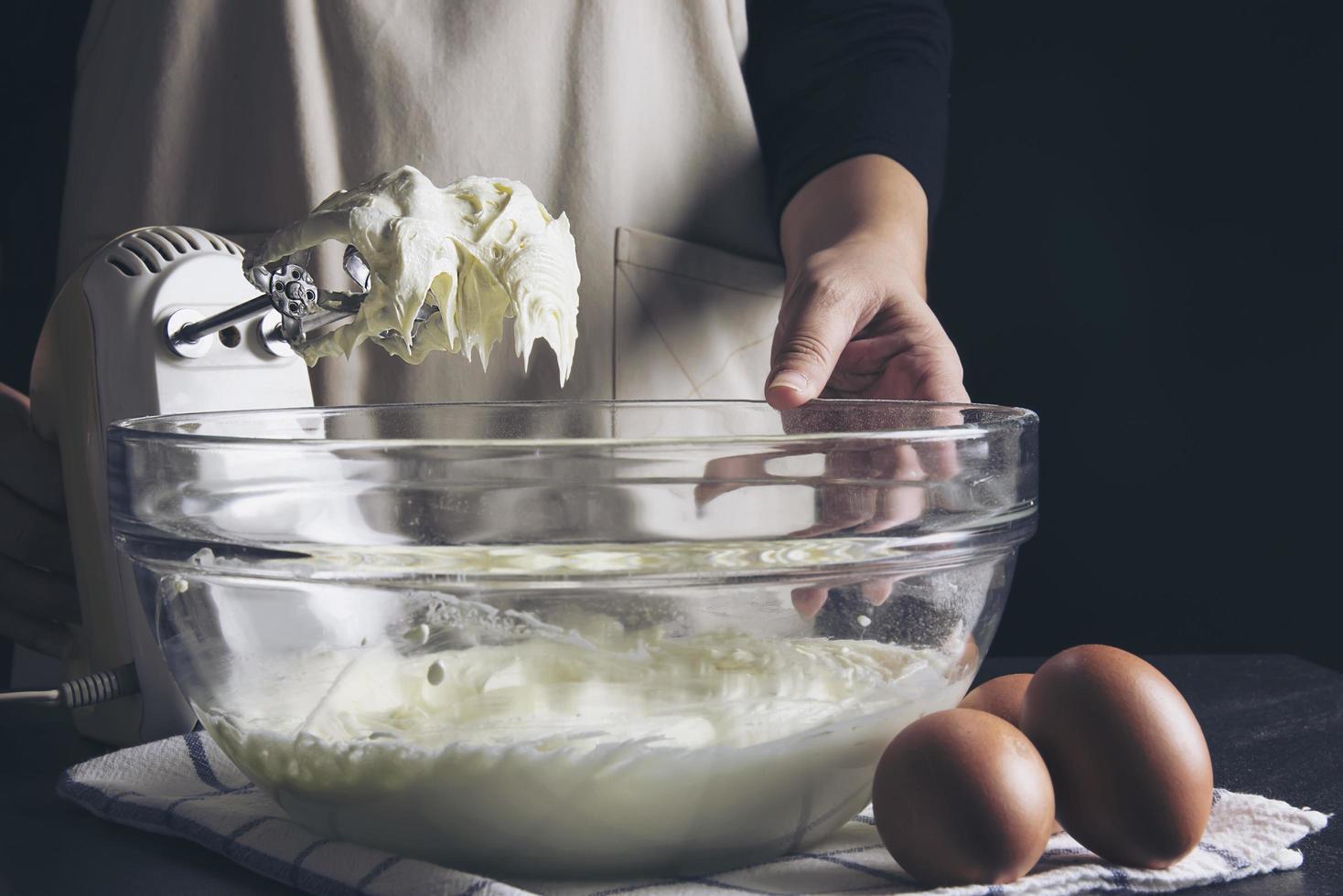 Lady making cake putting cream using spatula - homemade bakery cooking concept photo