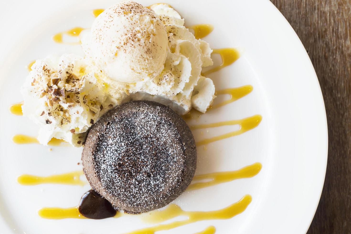 Chocolate lava cake in white plate on old wooden table photo