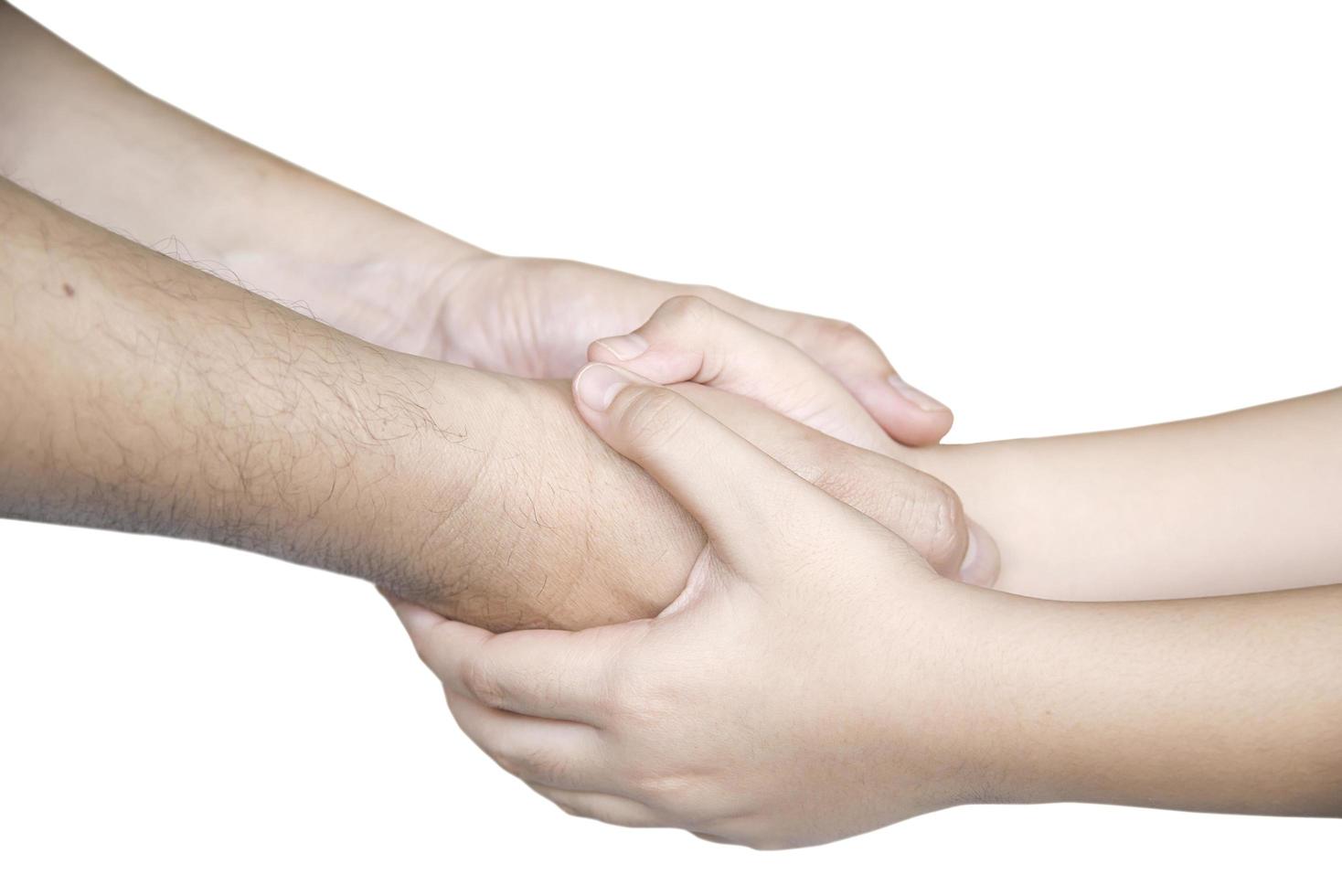 Father gentle holding son's hand over white background - people love help care each other concept photo