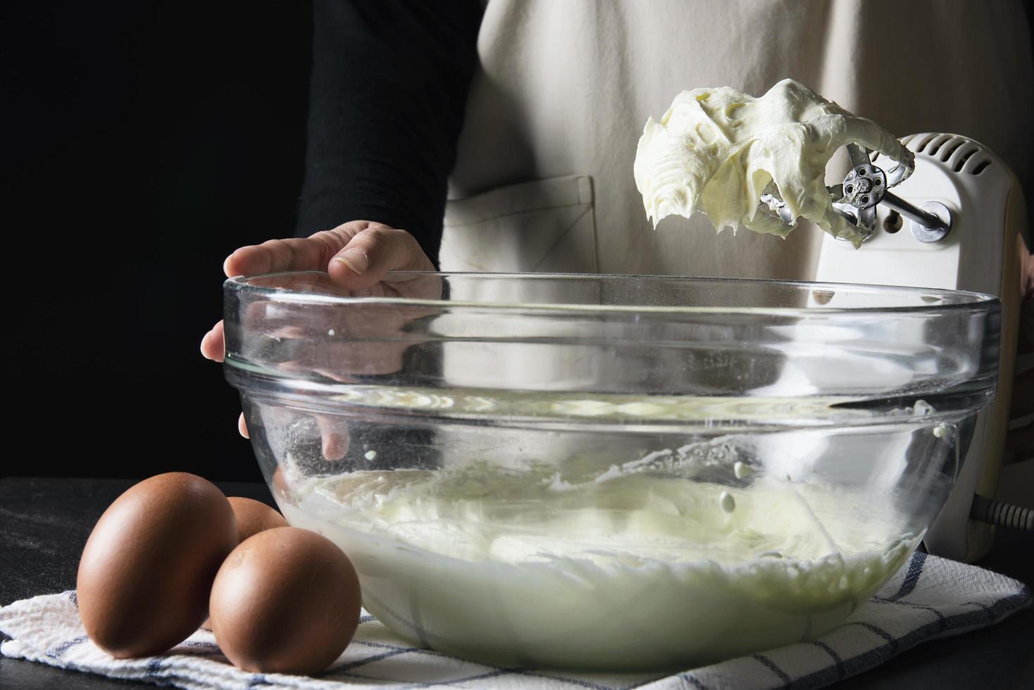 Lady making cake putting cream using spatula - homemade bakery cooking concept photo