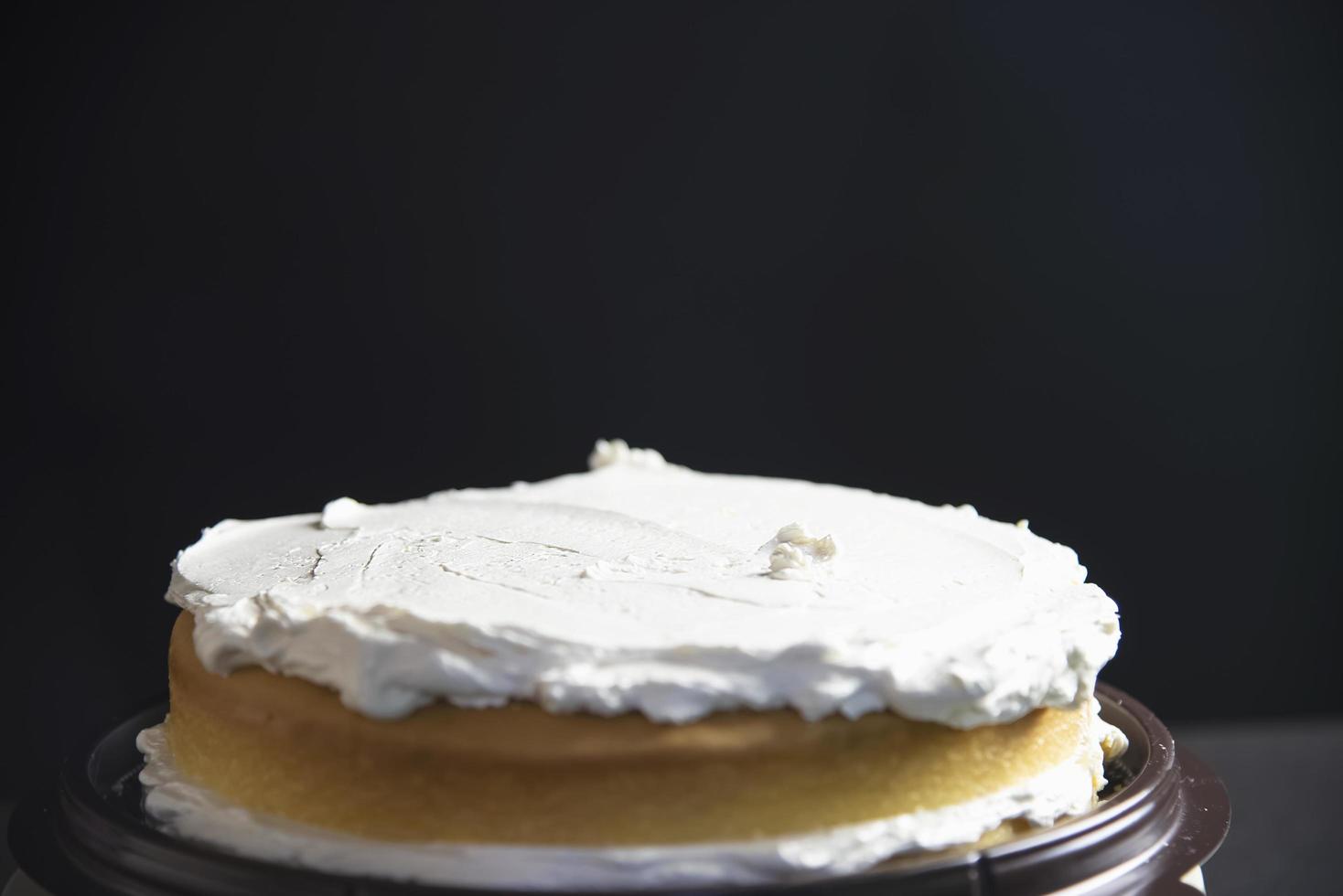 Lady making cake putting cream using spatula - homemade bakery cooking concept photo