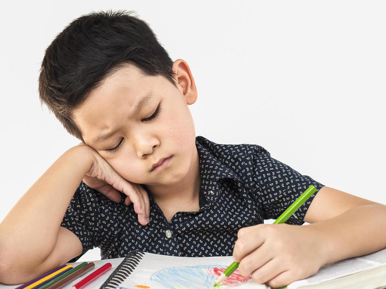 A boy is unhappy doing homework photo