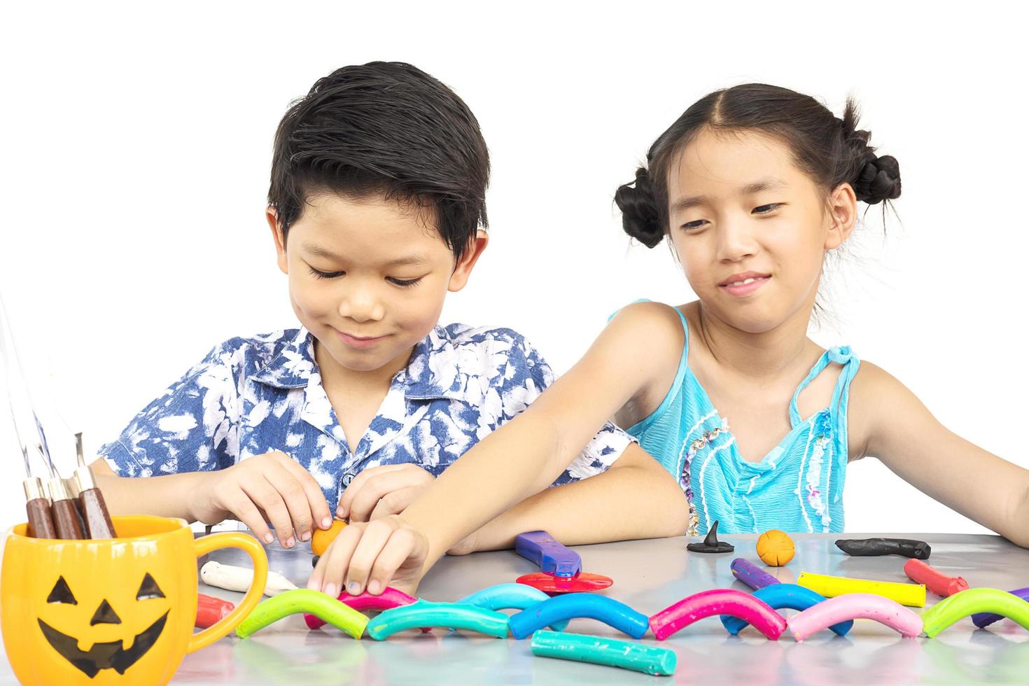 Boy and girl are happily playing clay toy photo