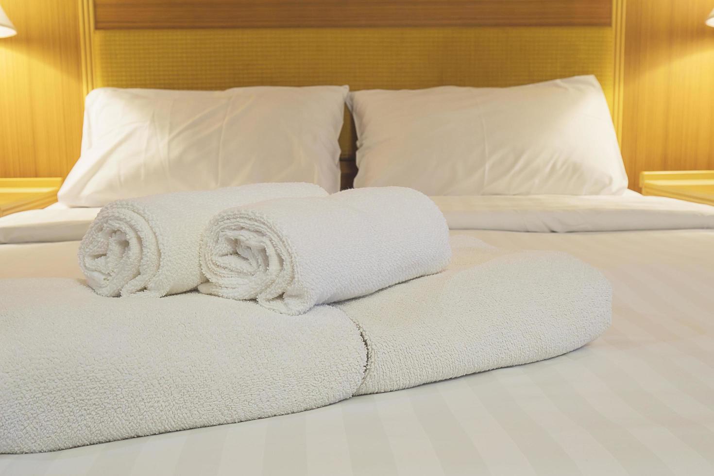 juego de toallas y ropa de cama blanca en un hotel moderno foto