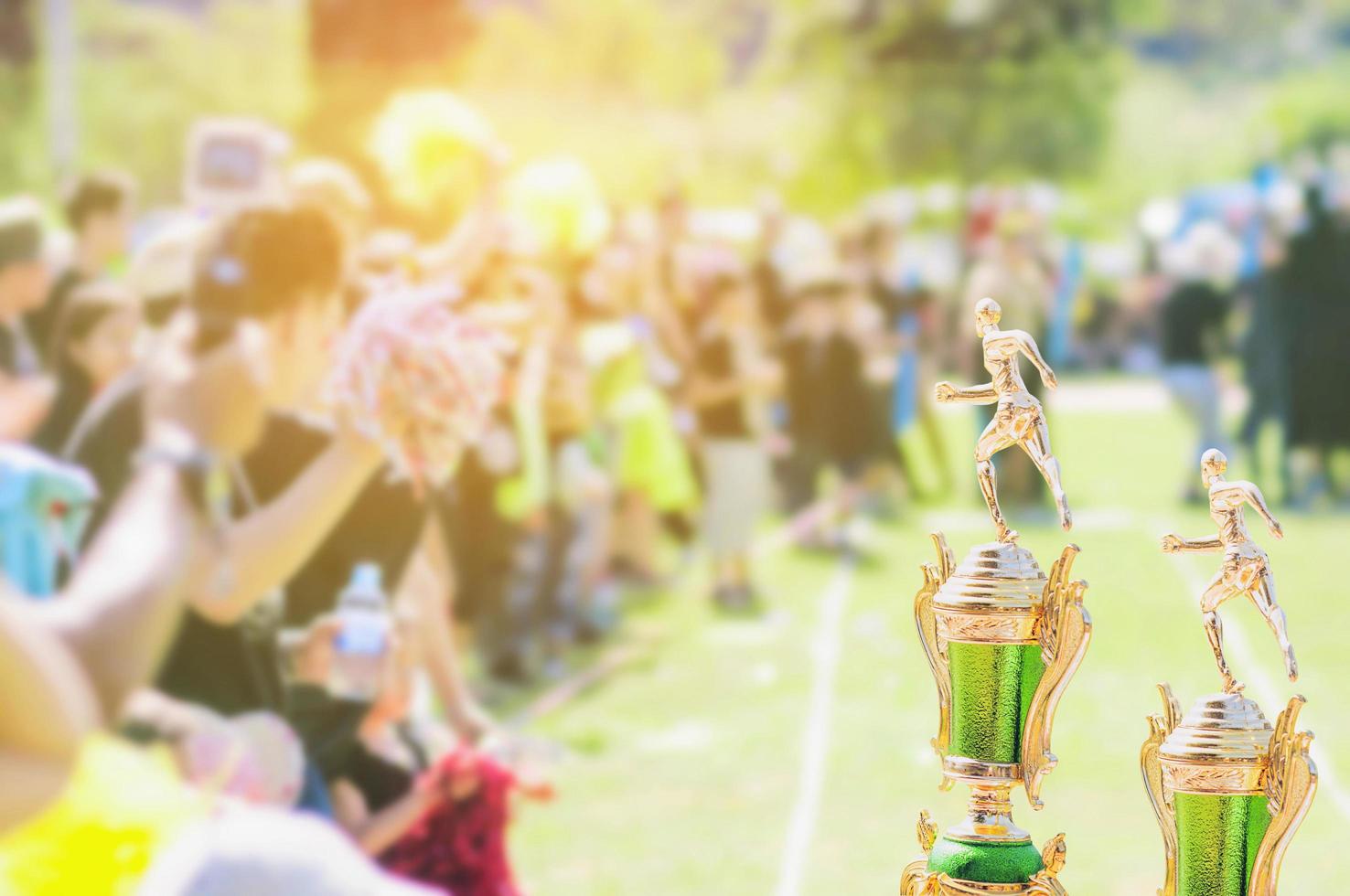 Sport trophy over blur crowded people in school sport day festival photo