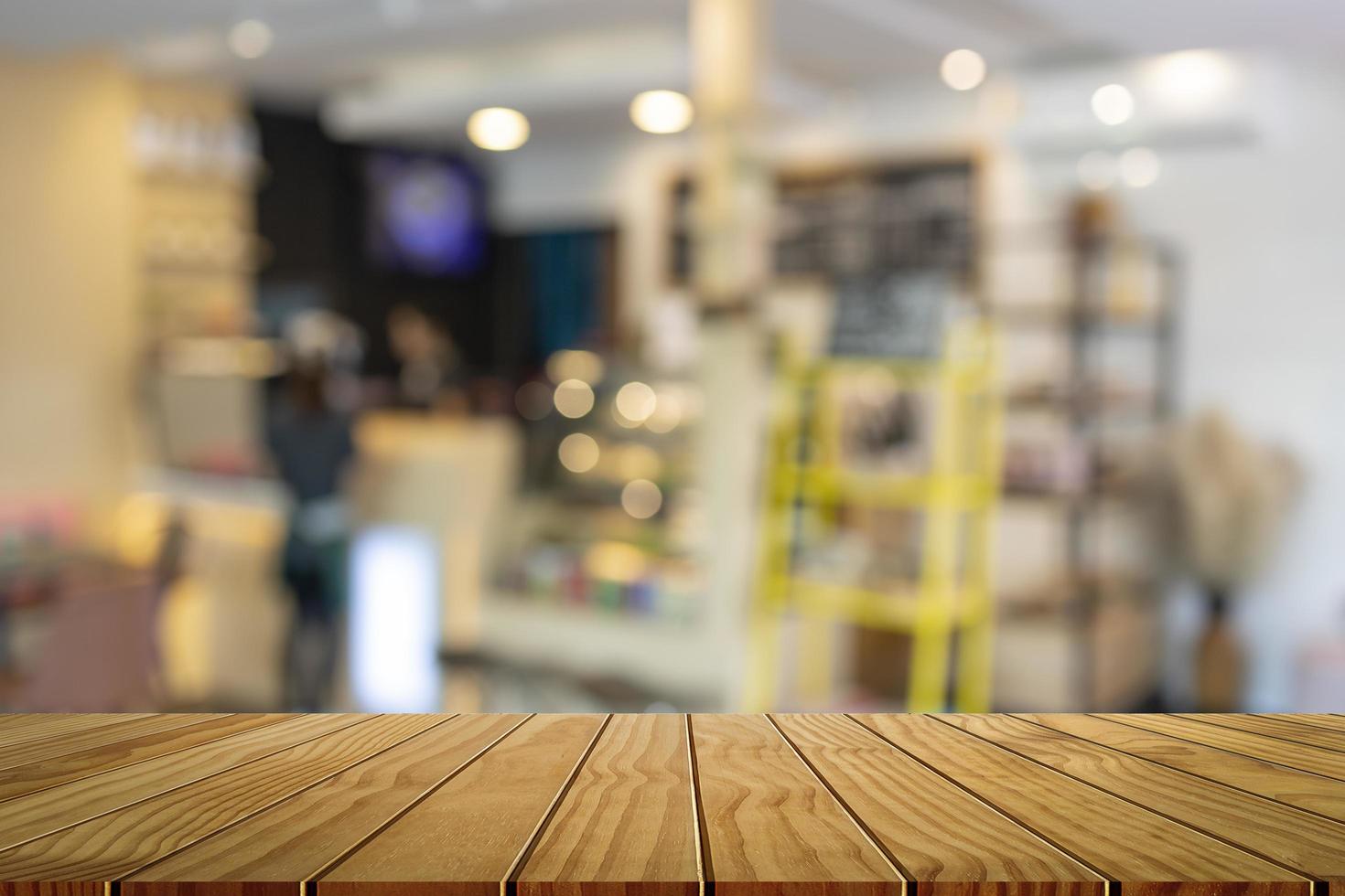 Wooden table in front of abstract blurred bar background. For montage