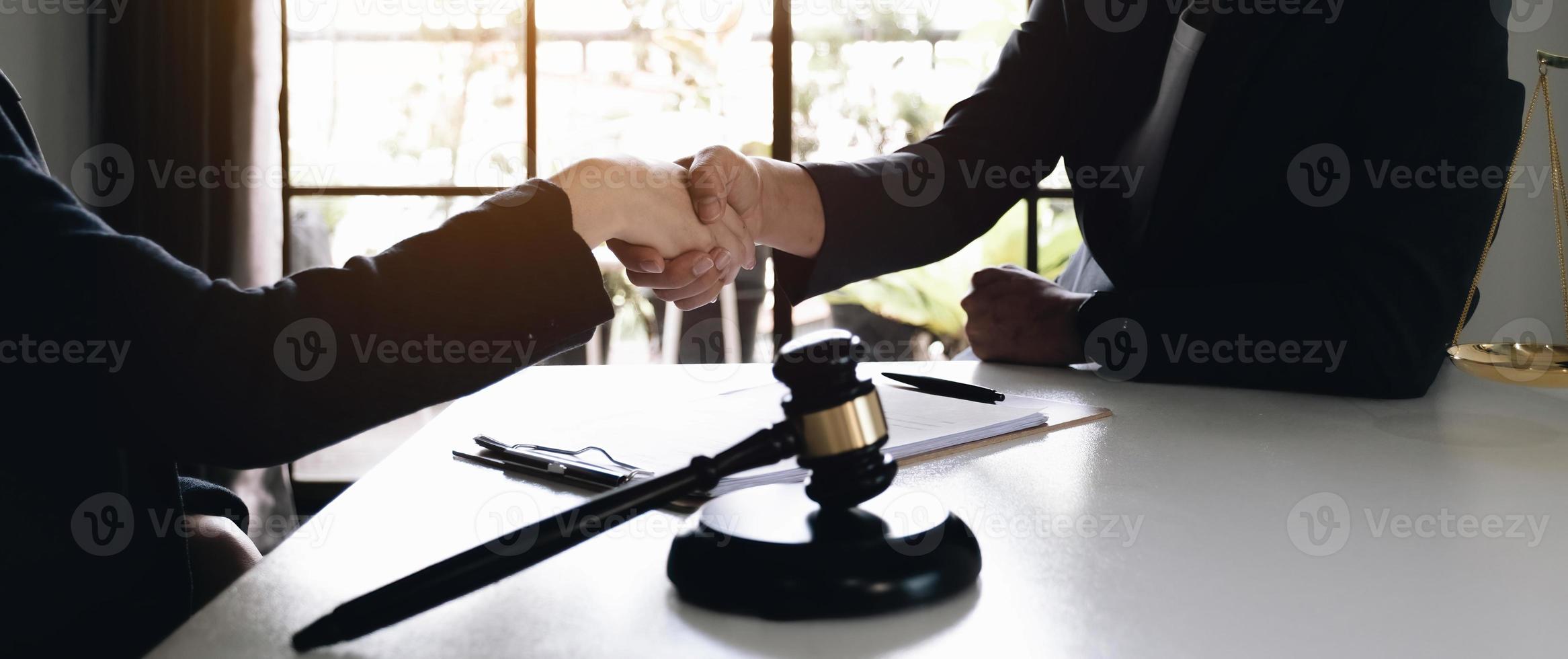 Lawyer business women shaking hands with clients, after finishing up a Consulting for insurance rent house. concept of home protection, family, insurance. photo