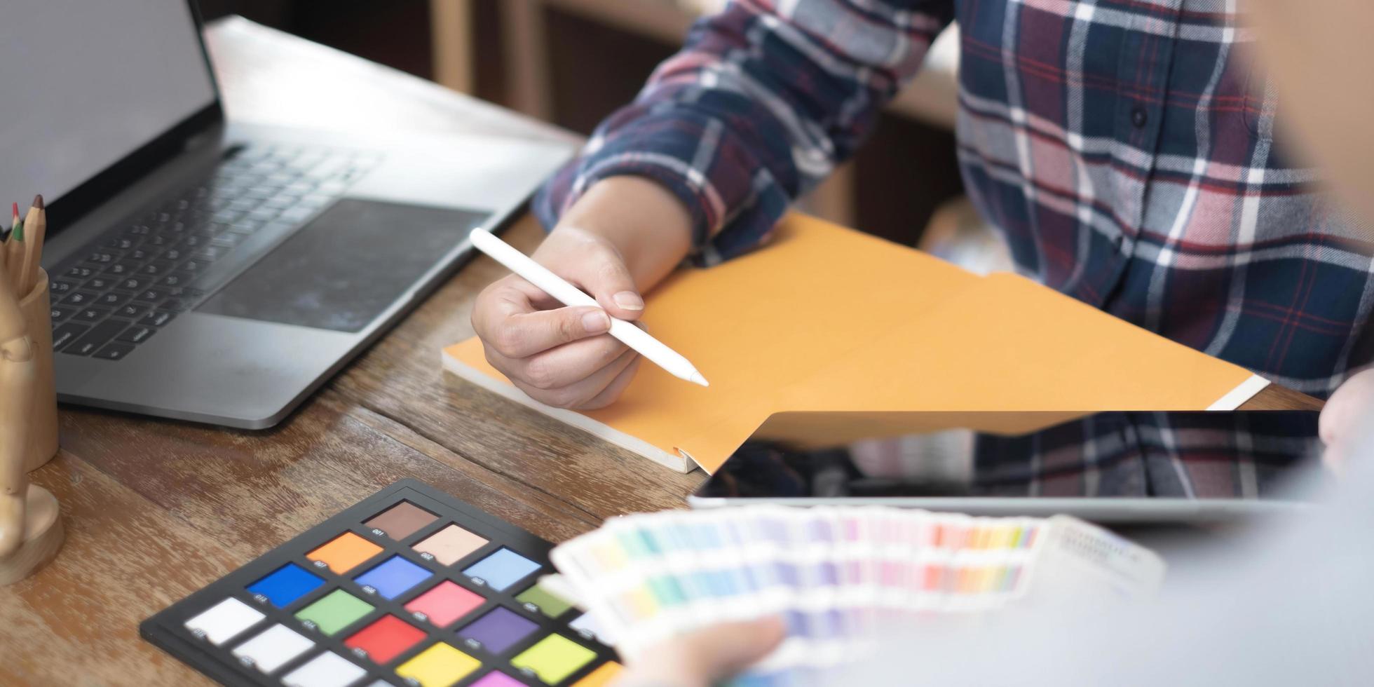 Team of creative graphic designer working on color swatch samples chart for selection coloring in inspiration to create new collection at workplace photo