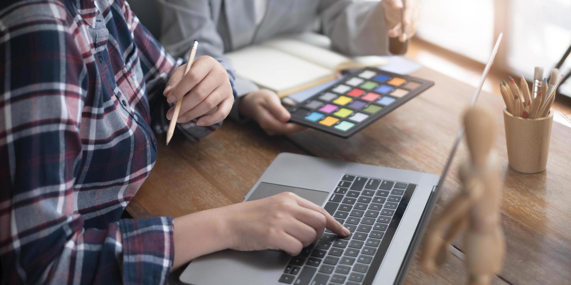 Team of creative graphic designer working on color swatch samples chart for selection coloring in inspiration to create new collection at workplace photo