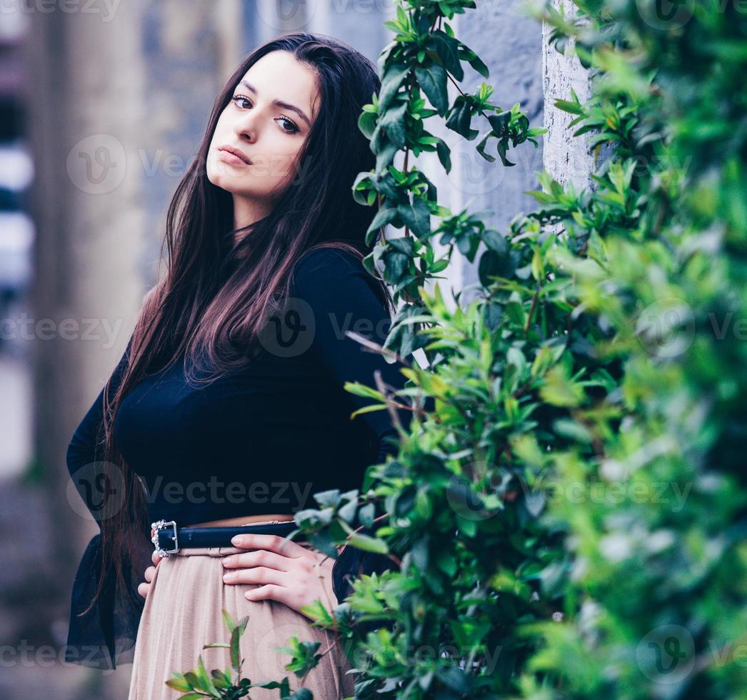 beautiful white european girl with clean skin poses on the street in the city photo