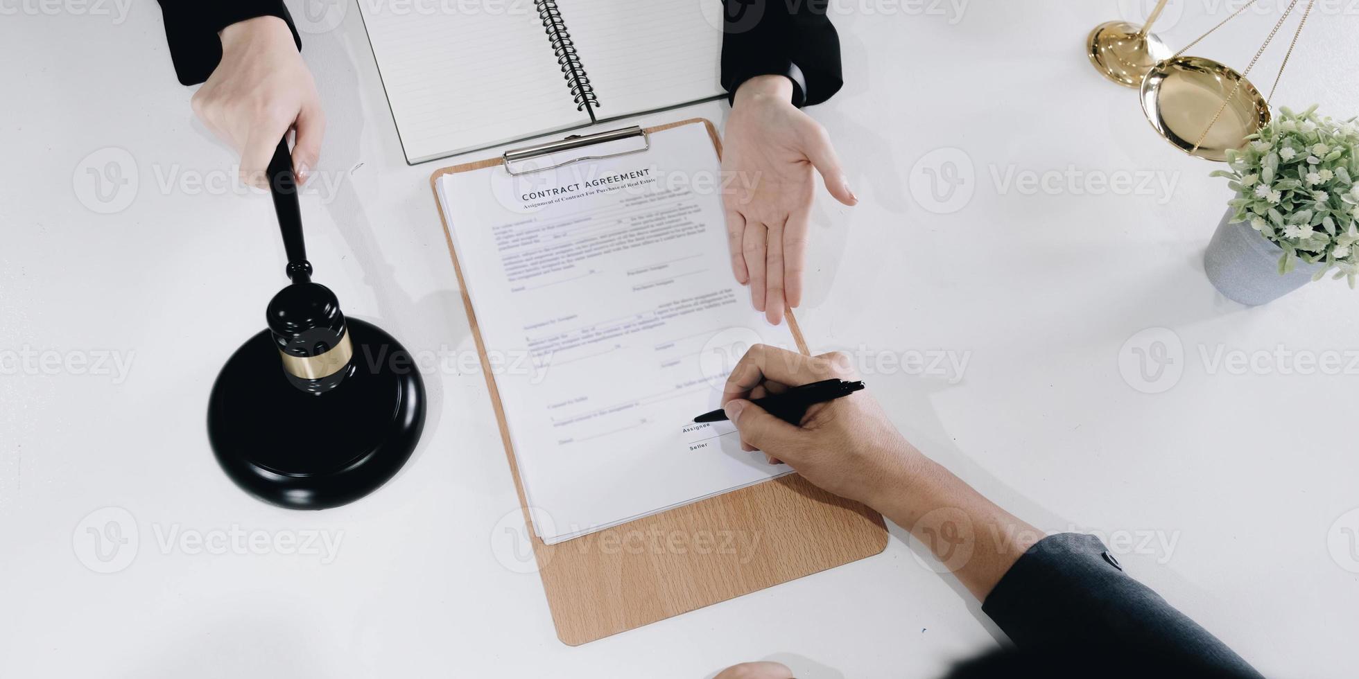 business people and lawyers discussing contract papers sitting at the table. Concepts of law, advice, legal services photo