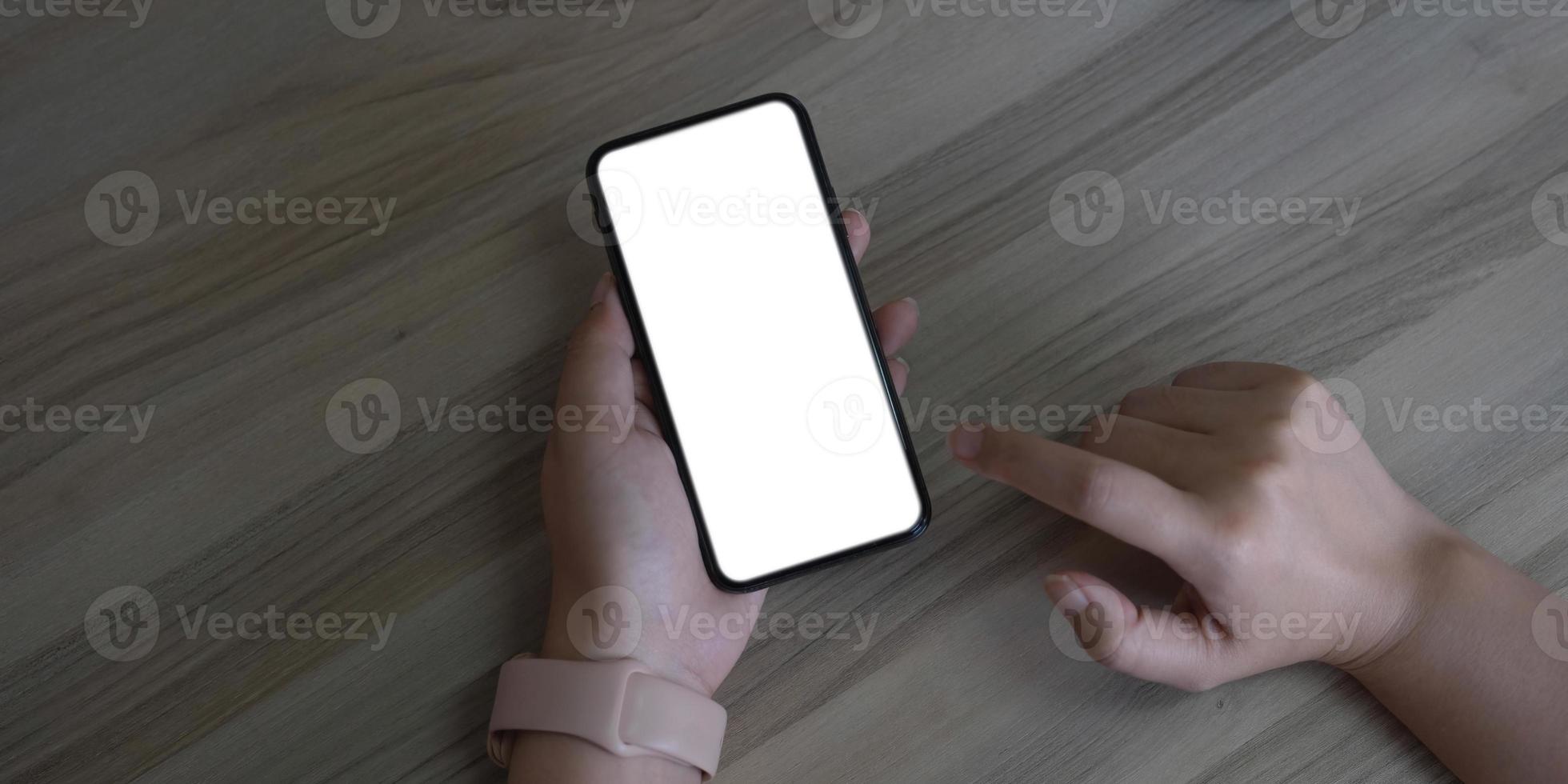 cell phone Mockup image blank white screen.woman hand holding texting using mobile on desk at coffee shop.background empty space for advertise text.people contact marketing business,technology photo