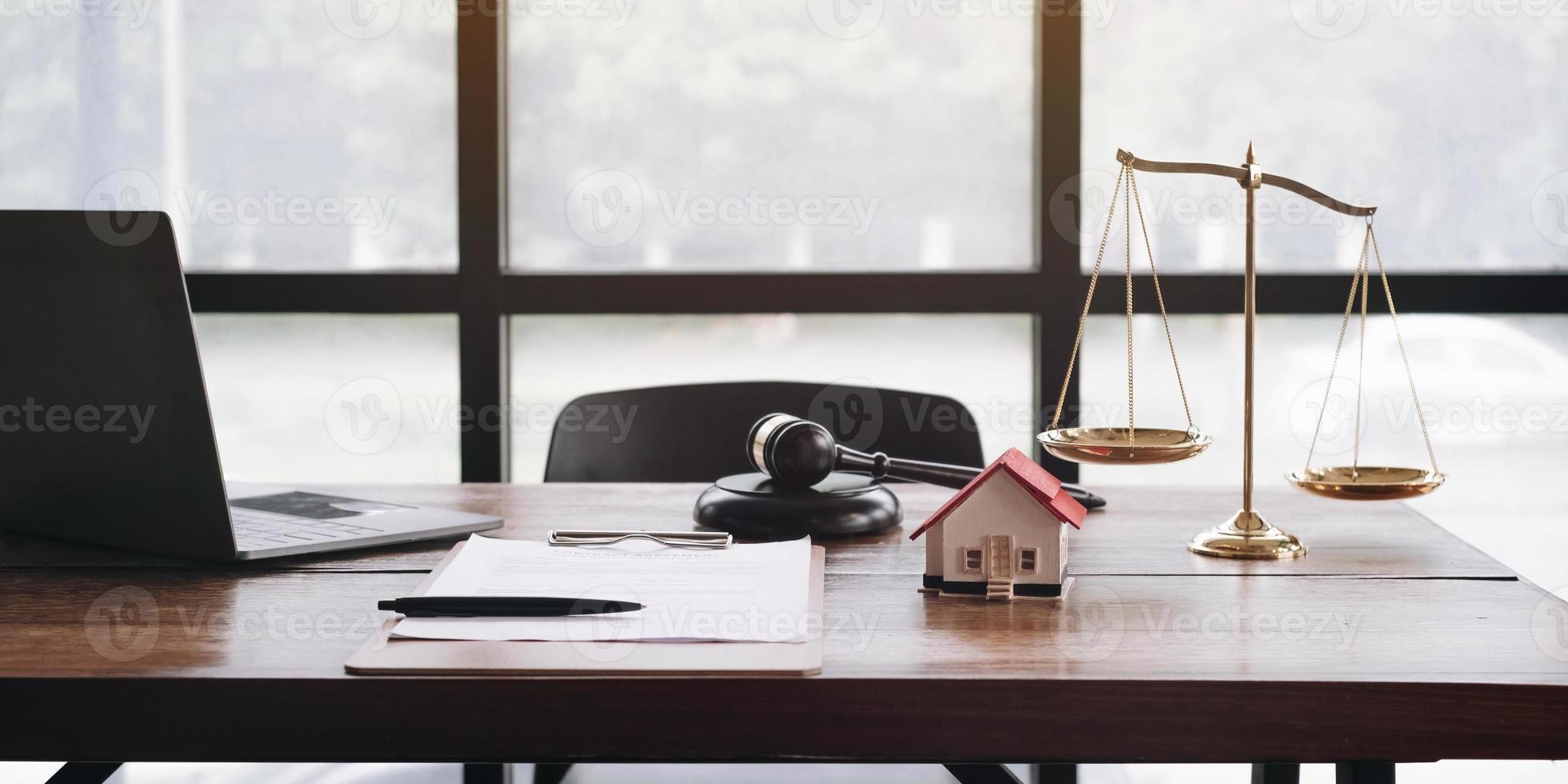 law legal technology concept. judge gavel on computer with scales of justice on desk of lawyer. photo