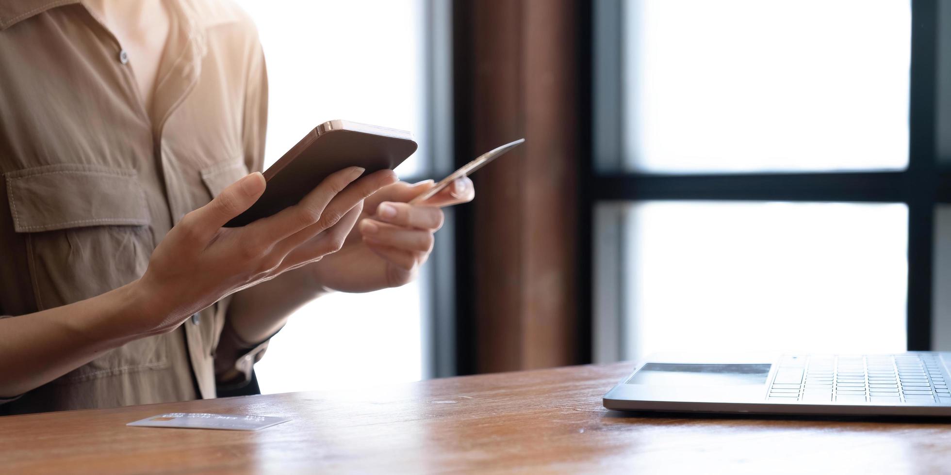 Close up woman paying online by credit card, using smartphone, entering information, young female holding phone, browsing banking service, checking balance, shopping, ordering in internet photo