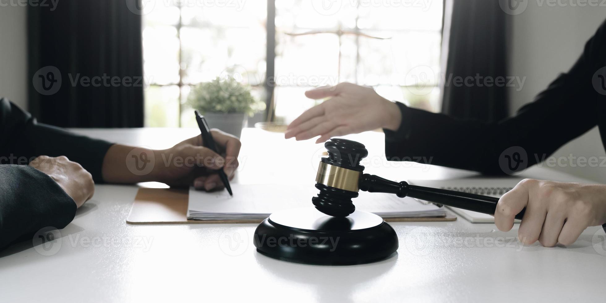 business people and lawyers discussing contract papers sitting at the table. Concepts of law, advice, legal services photo